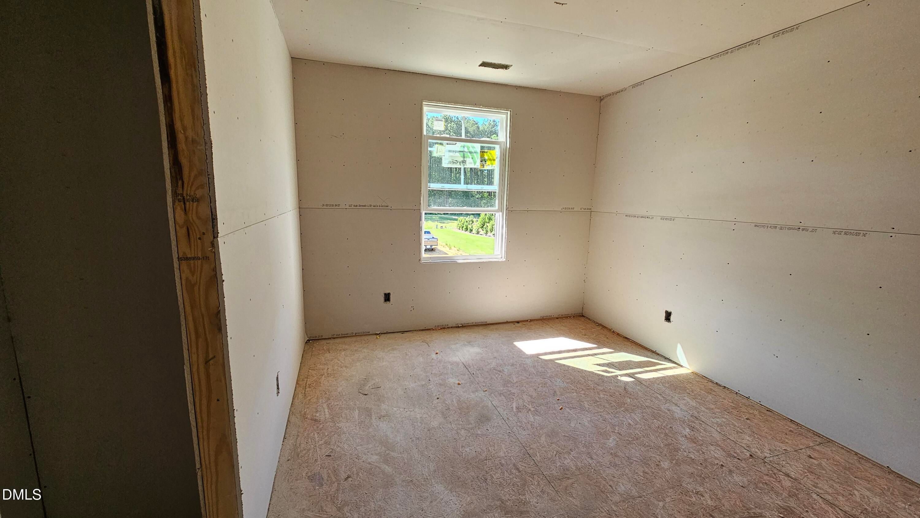 Unfinished bedroom with drywall installation in The Graham floor plan at Springvale, Fuquay-Varina, North Carolina.