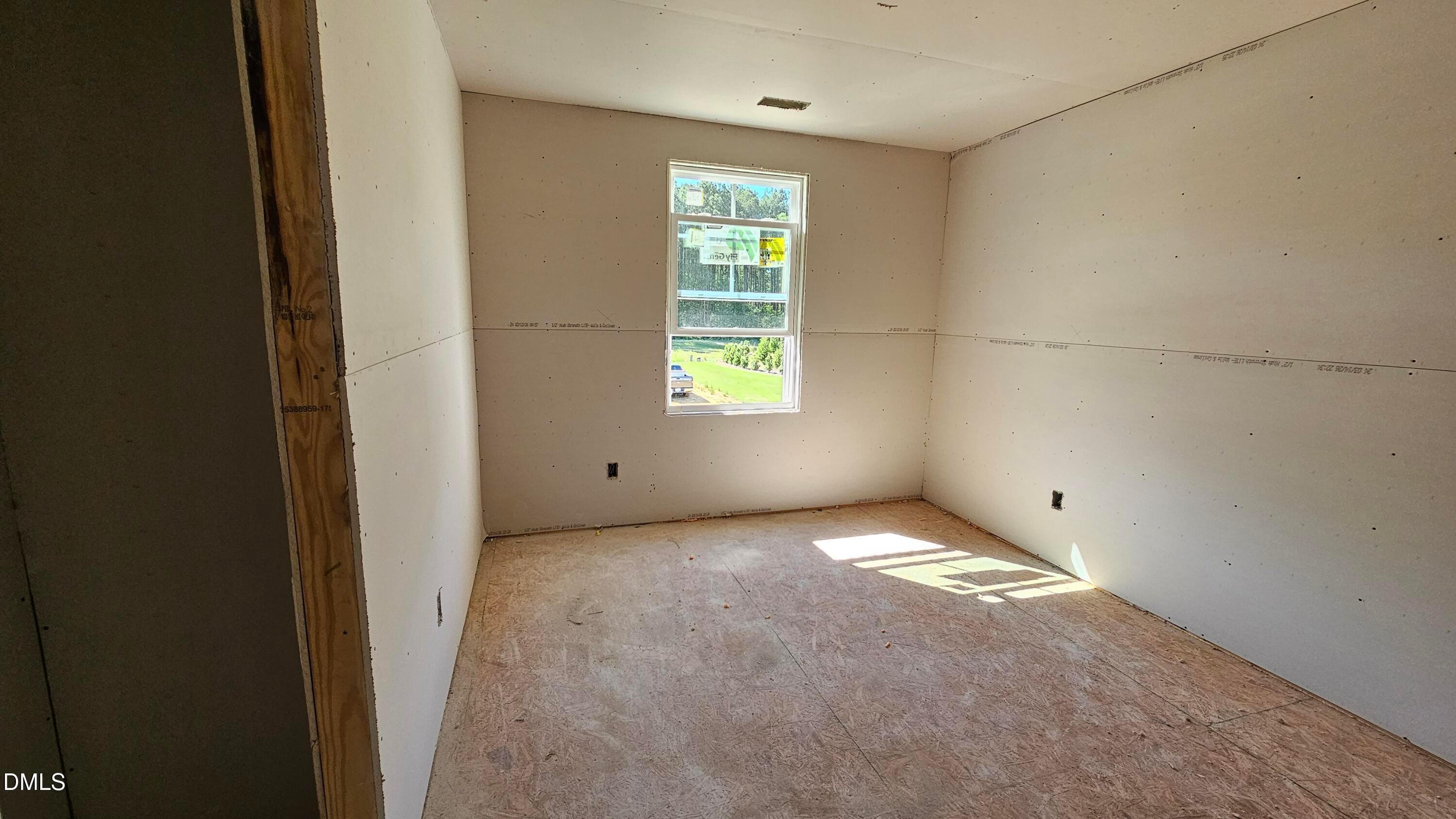 Unfinished bedroom with drywall installation in The Graham floor plan at Springvale, Fuquay-Varina, North Carolina.