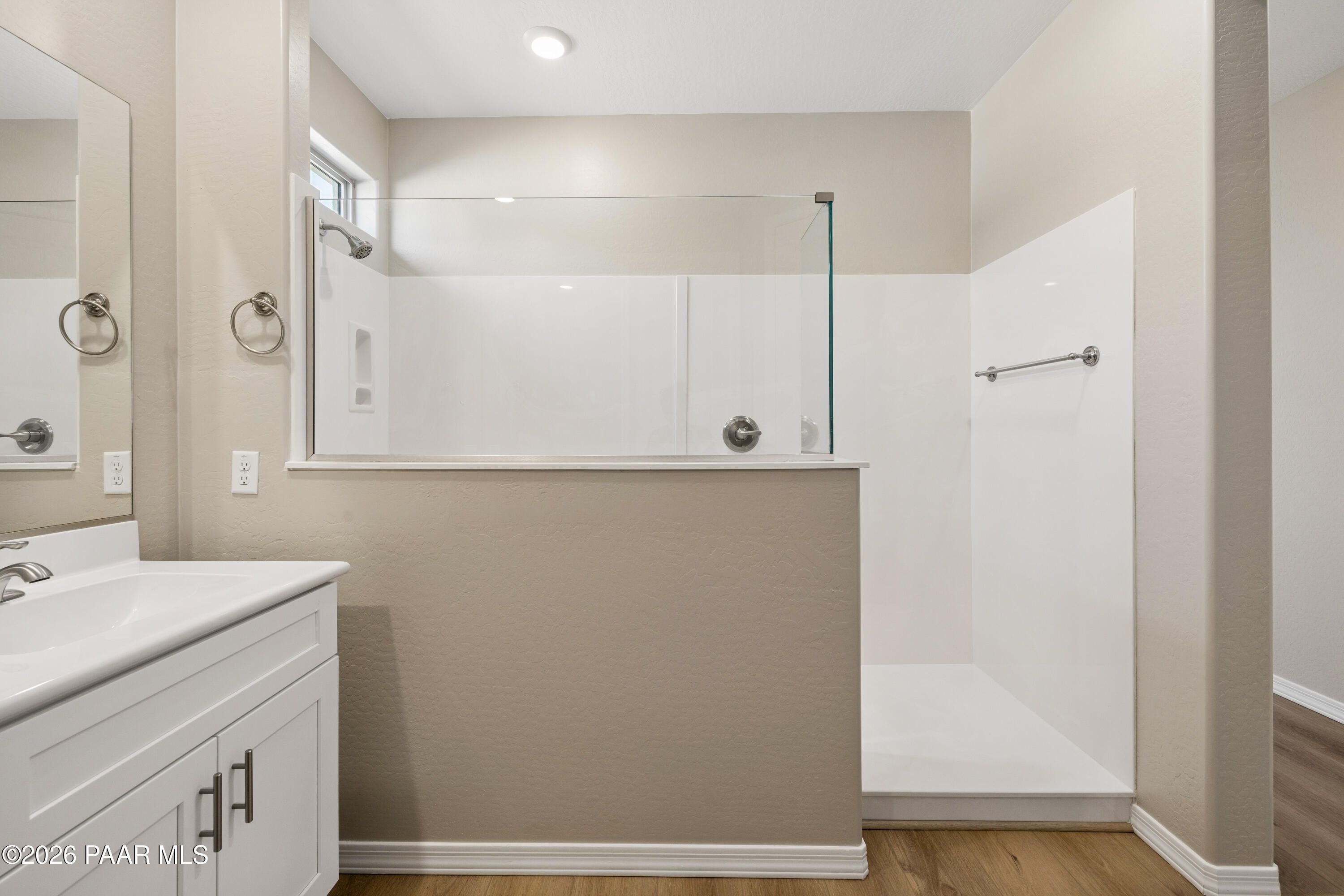 Modern master bathroom with frameless glass shower, double vanity, and neutral tones in Davidson Homes The Harmony A, Prescott Valley, AZ
