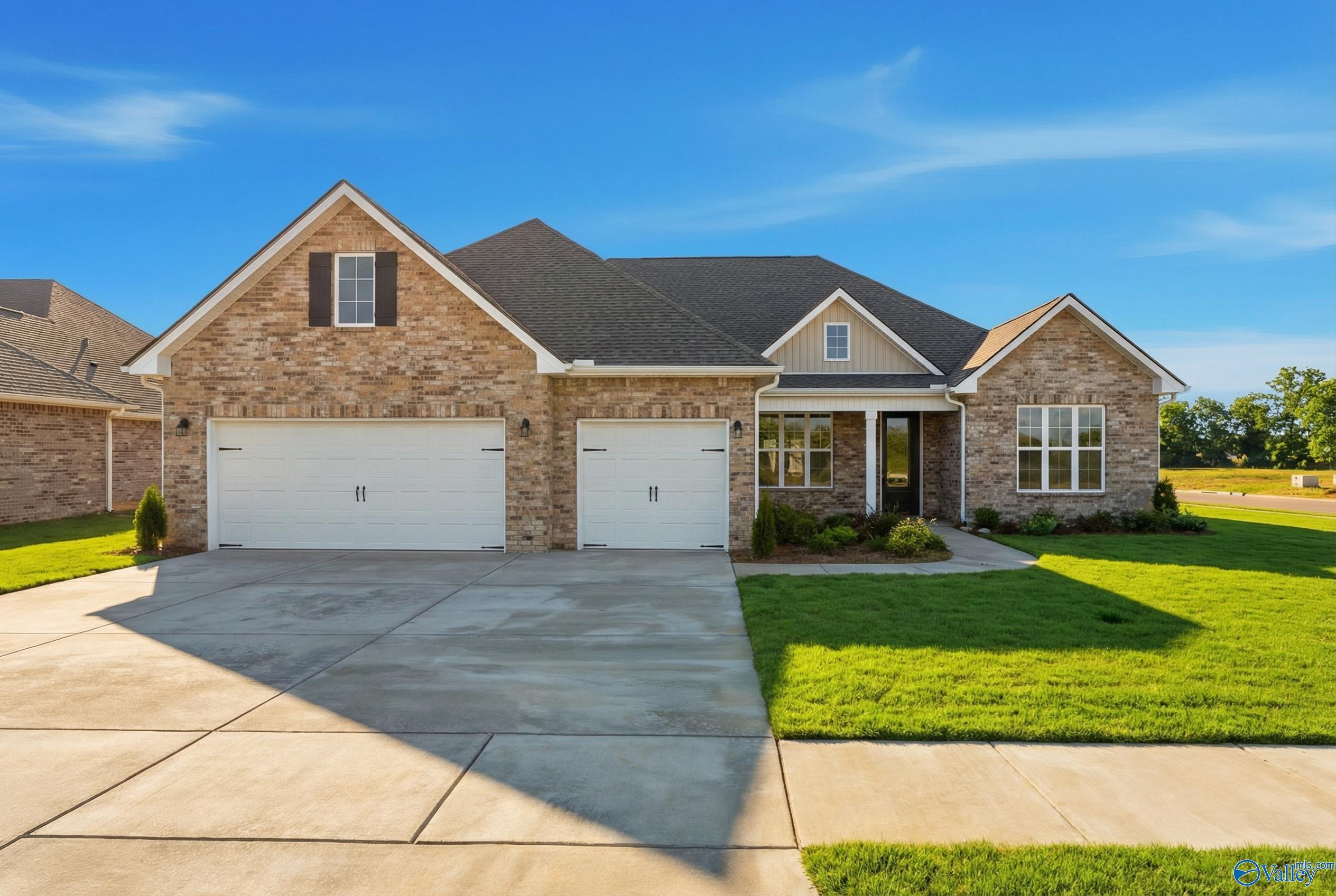 Brick ranch home exterior with gabled roof, 2-car garage, and landscaped yard in Briercreek, Meridianville, Alabama