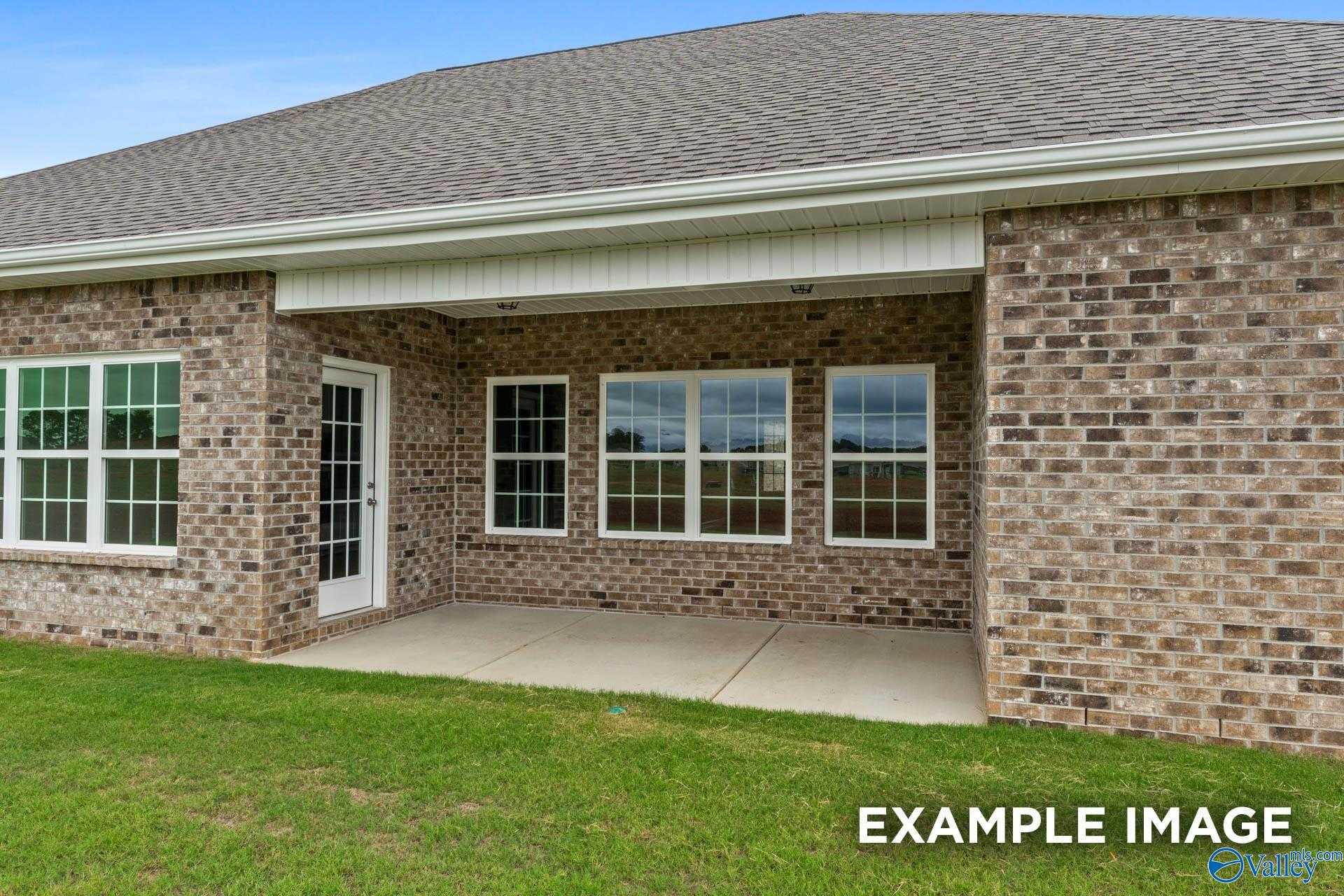 Covered brick patio with French doors and large windows on single-story Davidson Homes Finleigh in Creekside, Harvest, Alabama