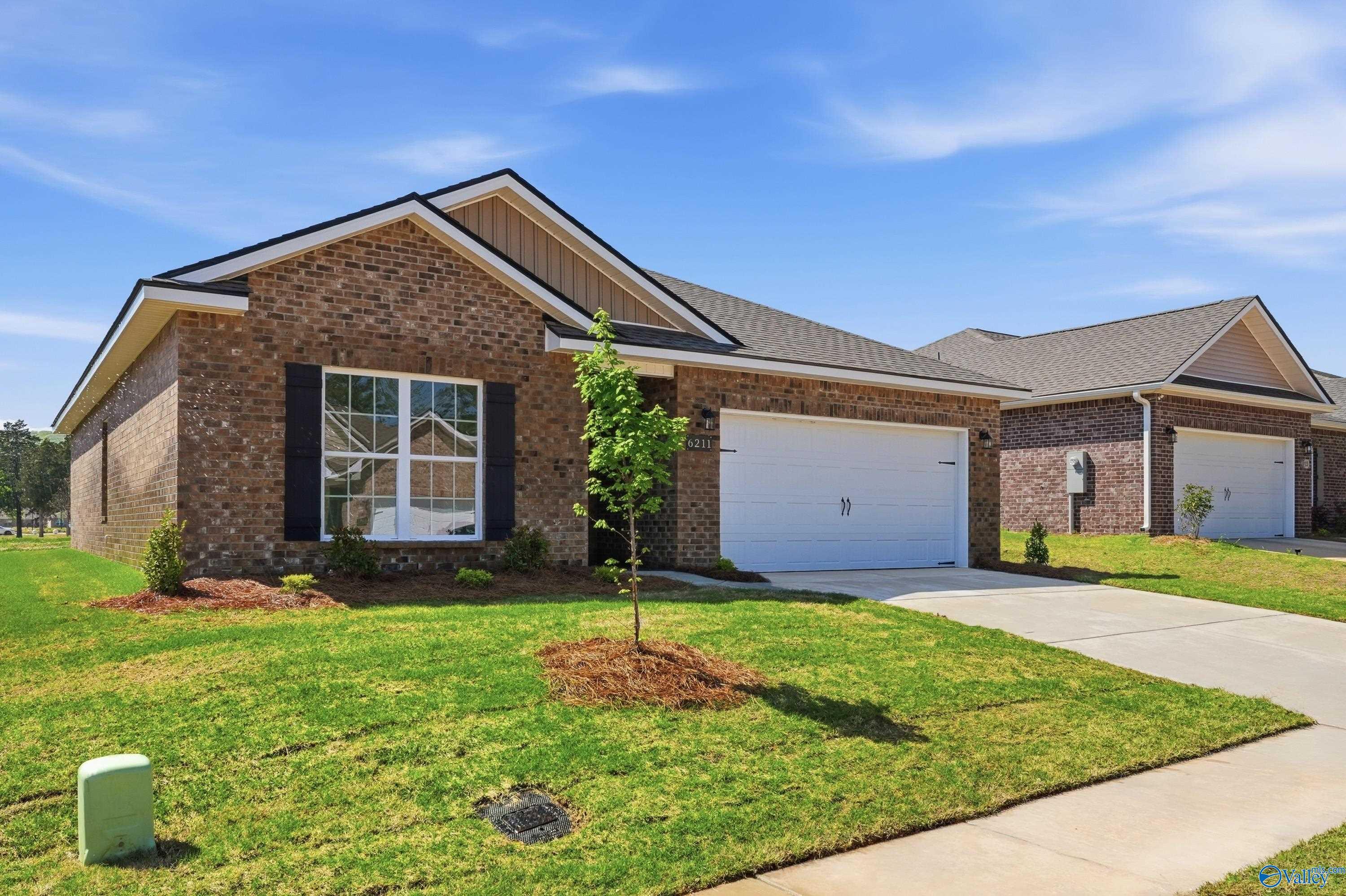 Brick exterior of The Asheville floor plan by Davidson Homes in Jaguar Hills, Huntsville, Alabama with 2-car garage.