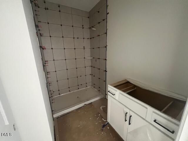 Bathroom under construction with tiled walk-in shower and white vanity in Davidson Homes The Magnolia II B, Lillington, NC