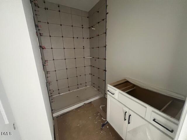 Bathroom under construction with tiled walk-in shower and white vanity in Davidson Homes The Magnolia II B, Lillington, NC