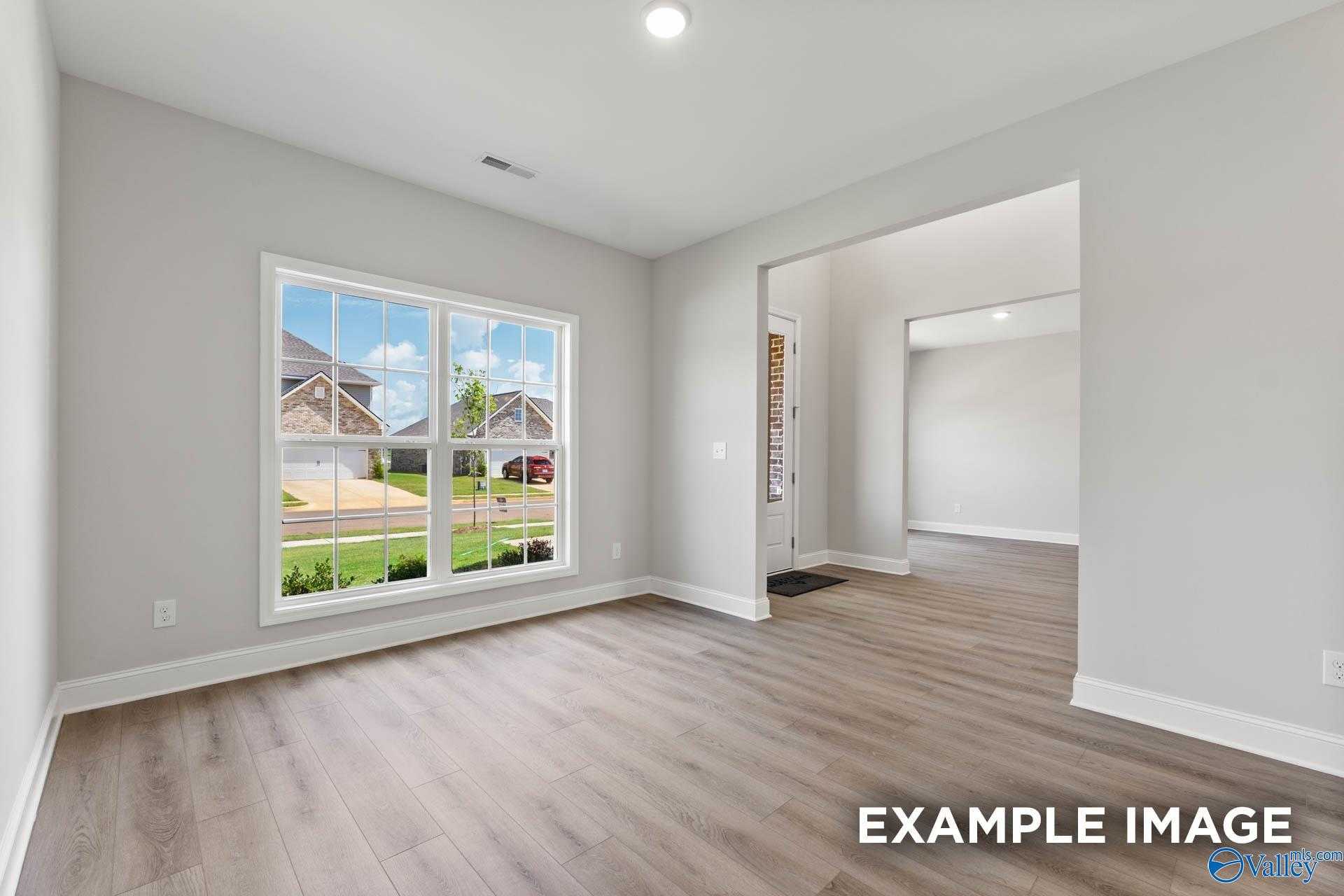 Sunlit office with large windows overlooking neighborhood in 5-bedroom Davidson Homes The Madison A, Creekside, Harvest, Alabama