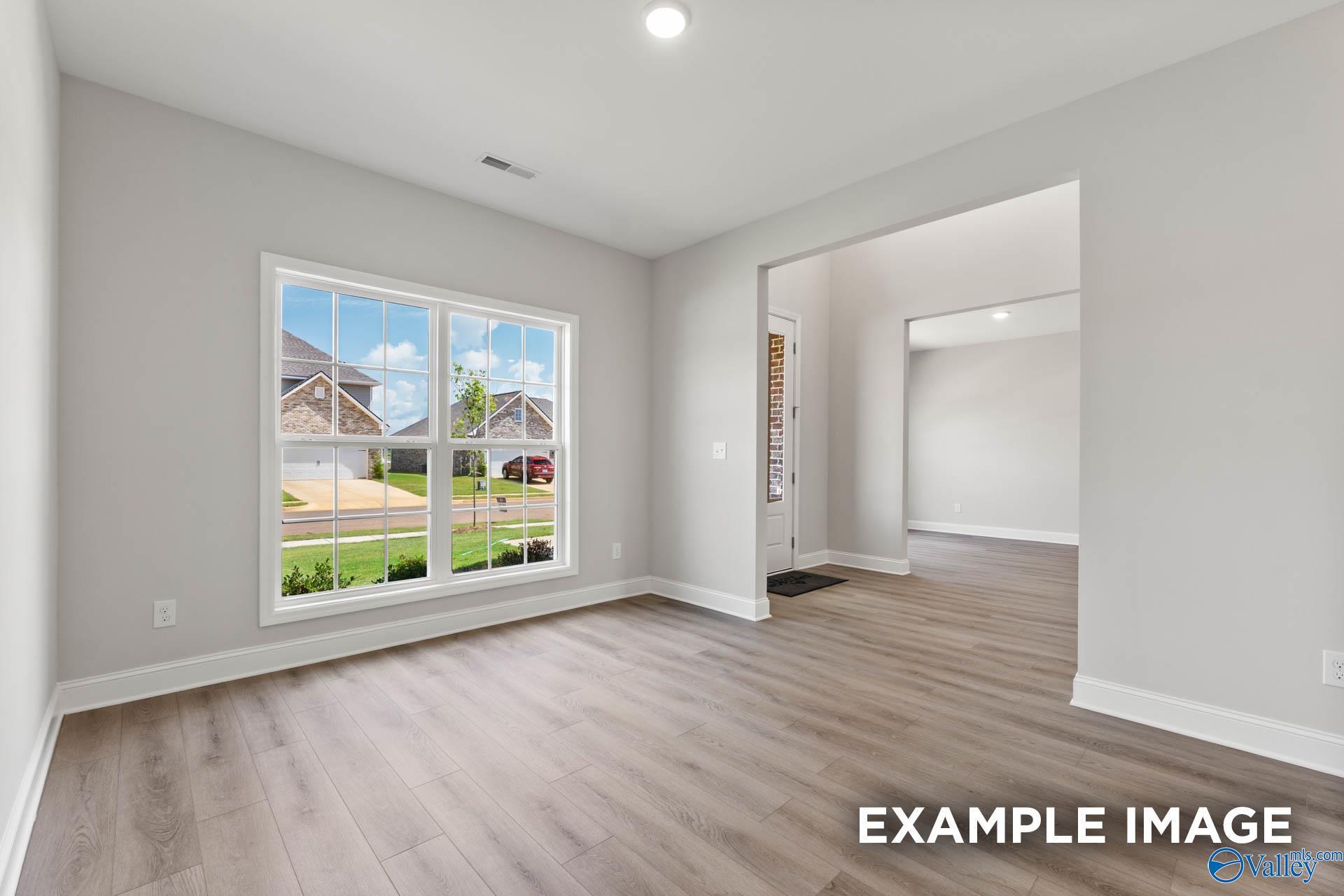 Bright study room with large windows showcasing suburban view in 5-bedroom Davidson Homes The Madison A, Meridianville, Alabama