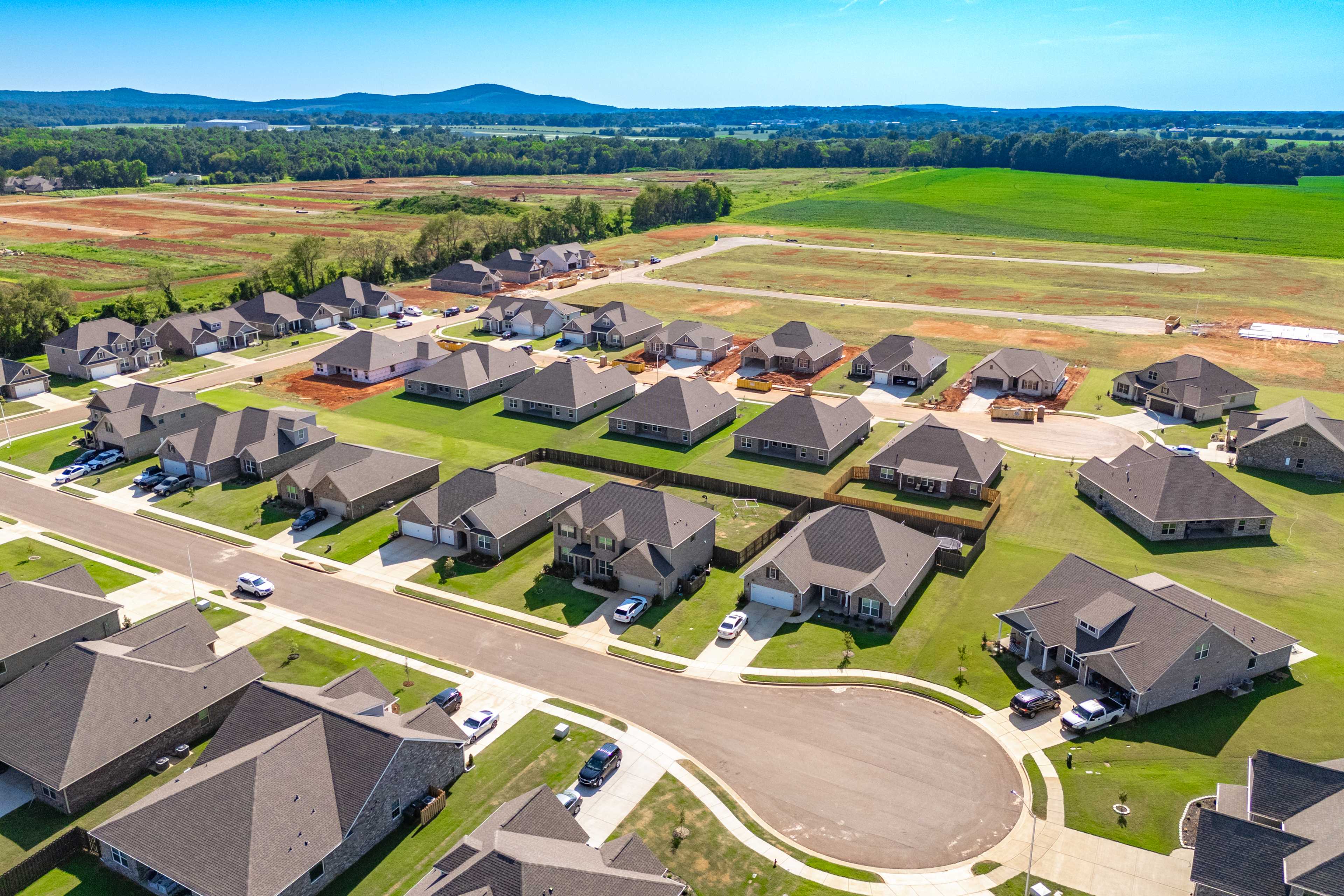 Aerial view of Pikes Ridge neighborhood in Meridianville Alabama by Davidson Homes with new single-family homes, construction sites, and rural fields