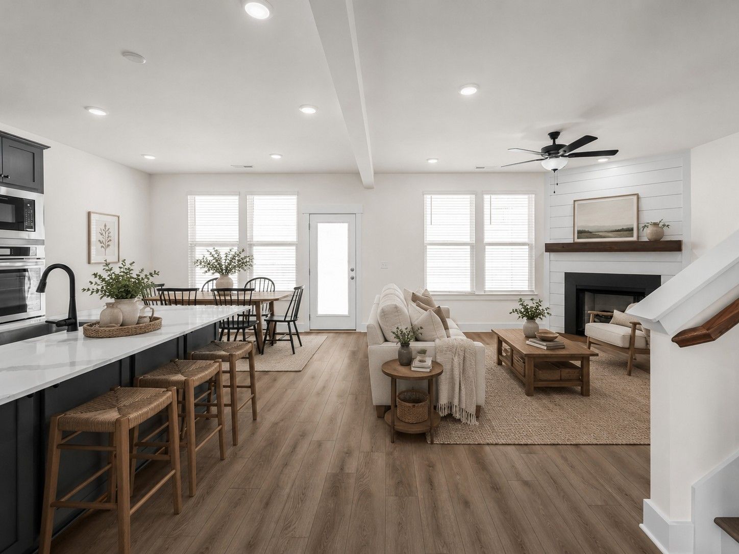 Open-concept living room and kitchen with fireplace in The Willow floor plan by Davidson Homes in Gallatin, Tennessee.