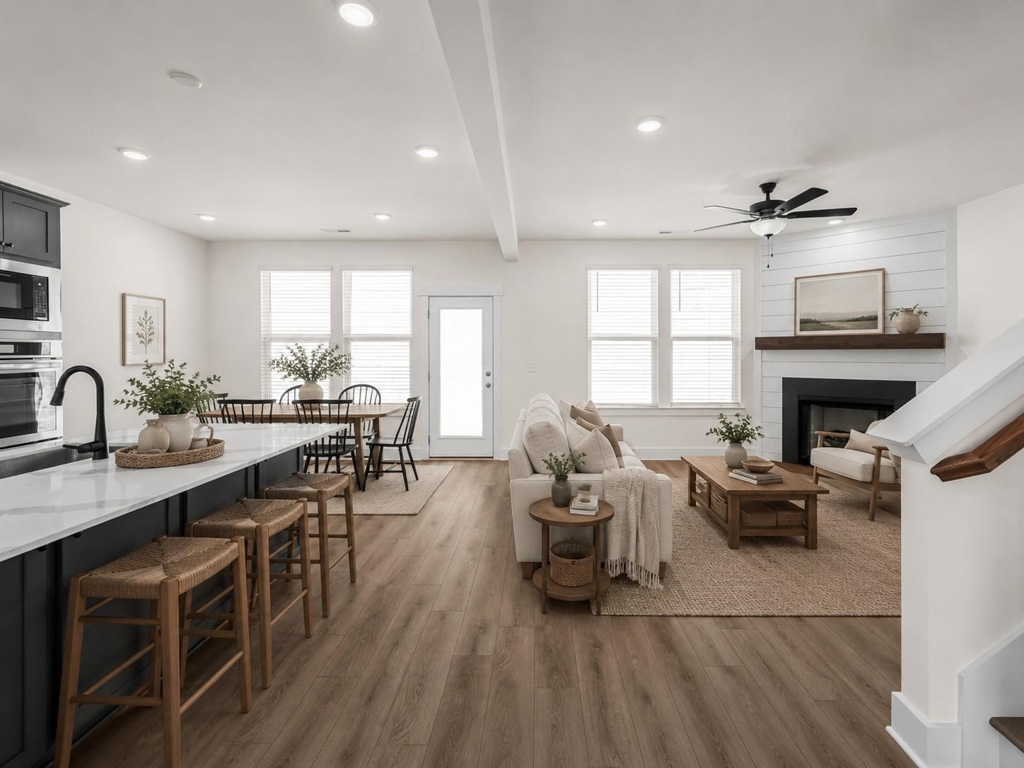 Open-concept living room and kitchen with fireplace in The Willow floor plan by Davidson Homes in Gallatin, Tennessee.