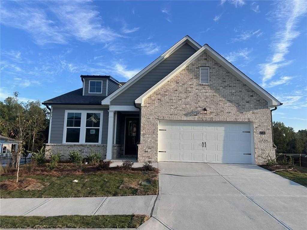 Modern gray brick ranch home with 2-car garage, gabled roof, and front yard landscaping in Davidson Homes The Glenwood C, Kelly Preserve, Loganville, GA
