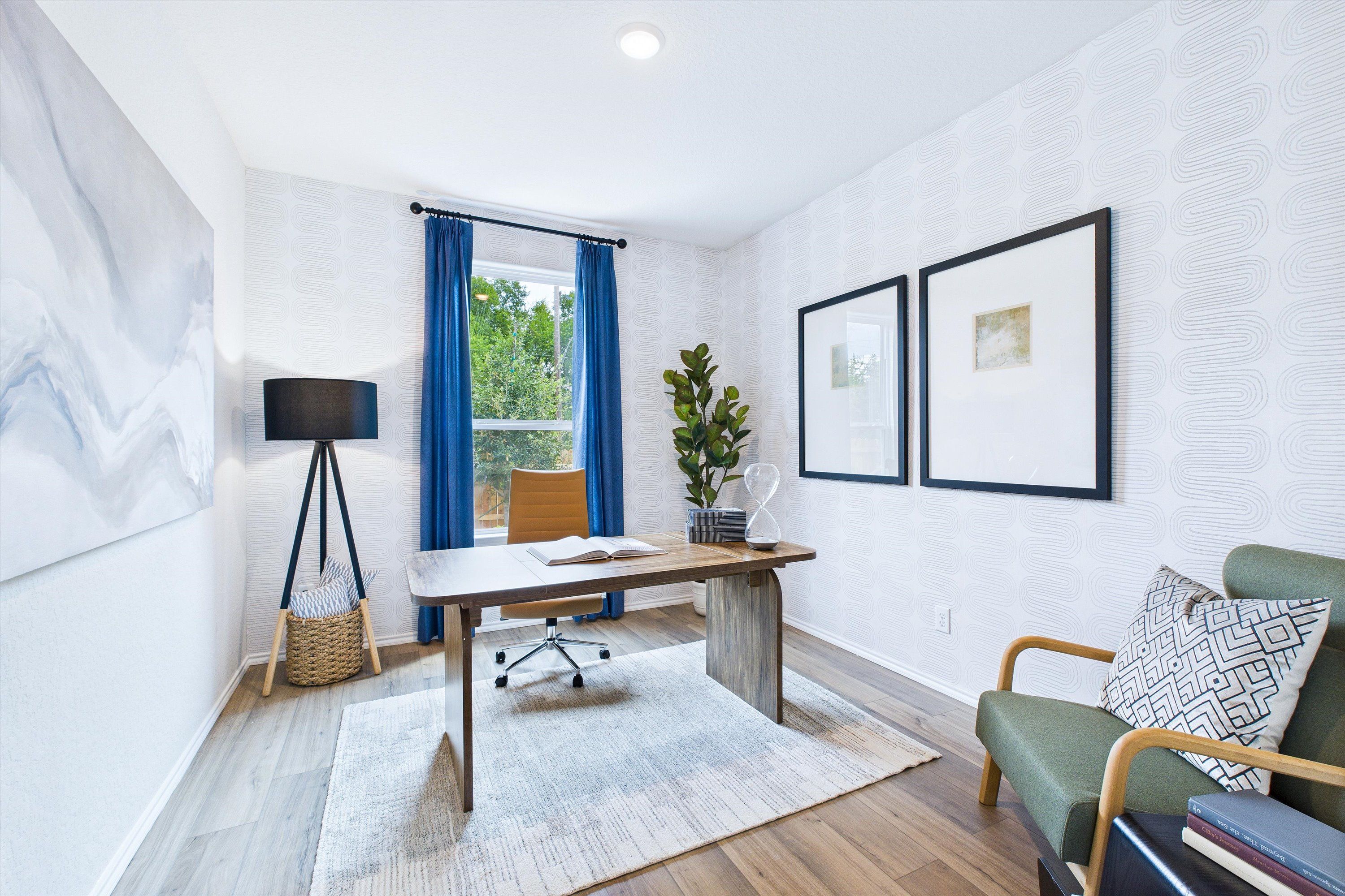 Modern home office in Cedar Heights San Antonio with wooden desk, blue curtains, potted plant, and green accent chair