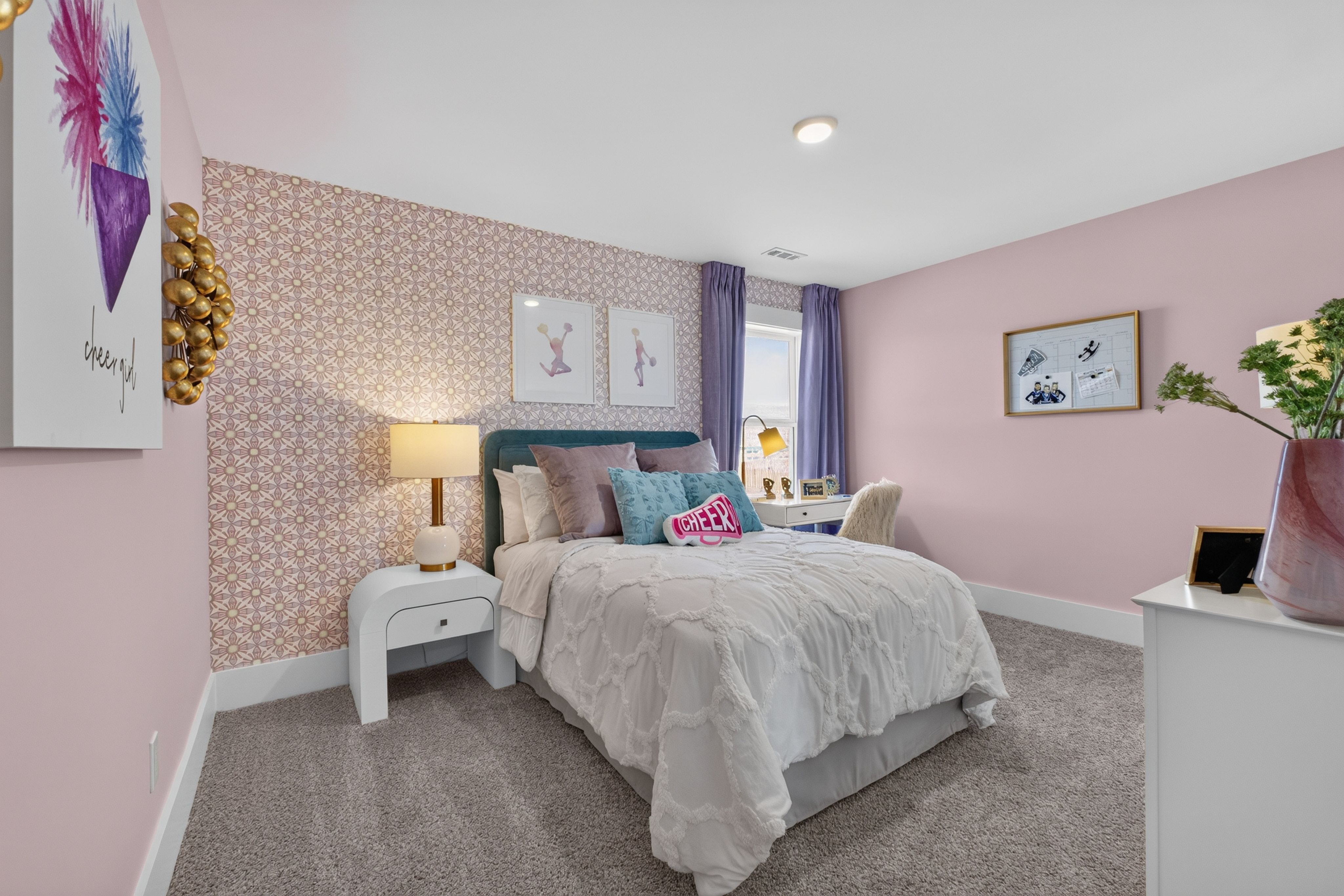 Pink bedroom with teal headboard and patterned accent wall at Evergreen Mill by Davidson Homes in Madison, Alabama