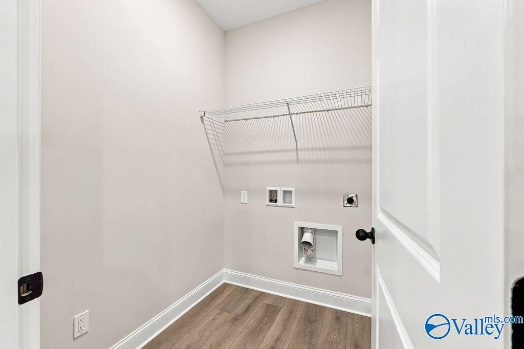 Laundry room with wire shelving and utility hookups in The Camilla C floor plan at The Retreat at Cain Park, Hartselle, AL.
