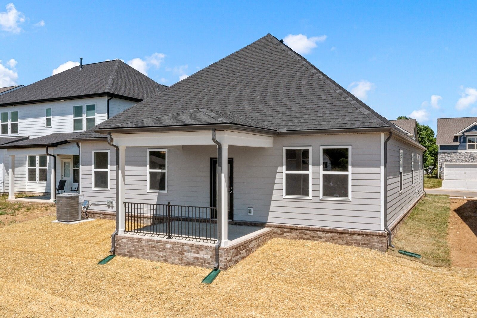 Back view of The Cottonwood E floor plan by Davidson Homes featuring a covered patio in Woods Crossing, Gallatin, Tennessee.