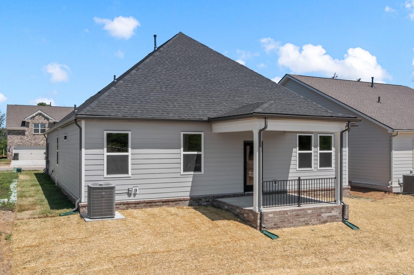 Rear view of The Cottonwood E floor plan by Davidson Homes featuring a covered patio in Woods Crossing, Gallatin, Tennessee.