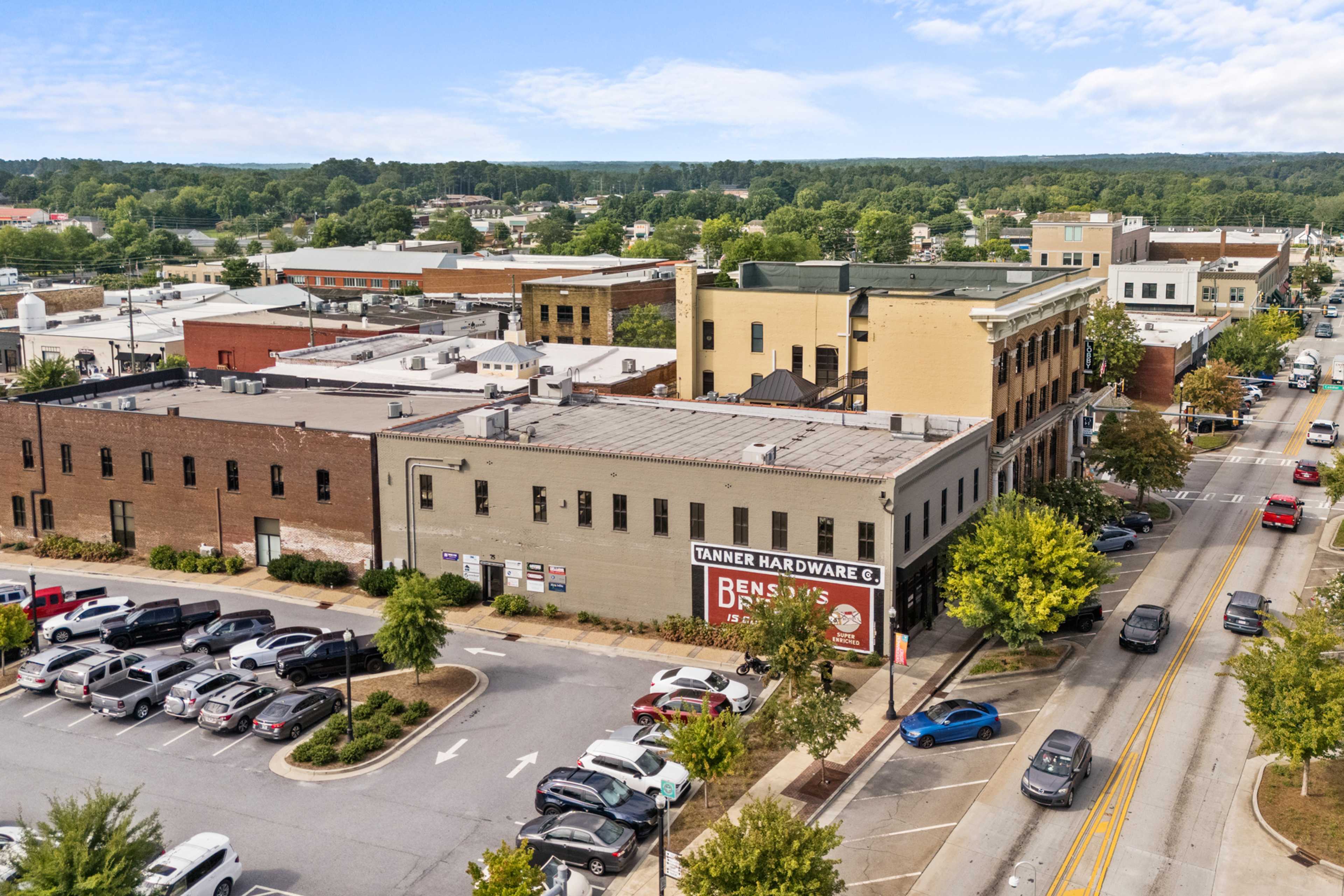 Aerial view of downtown Winder Georgia near Lake Shore community with Davidson Homes building, brick storefronts, and tree-lined streets