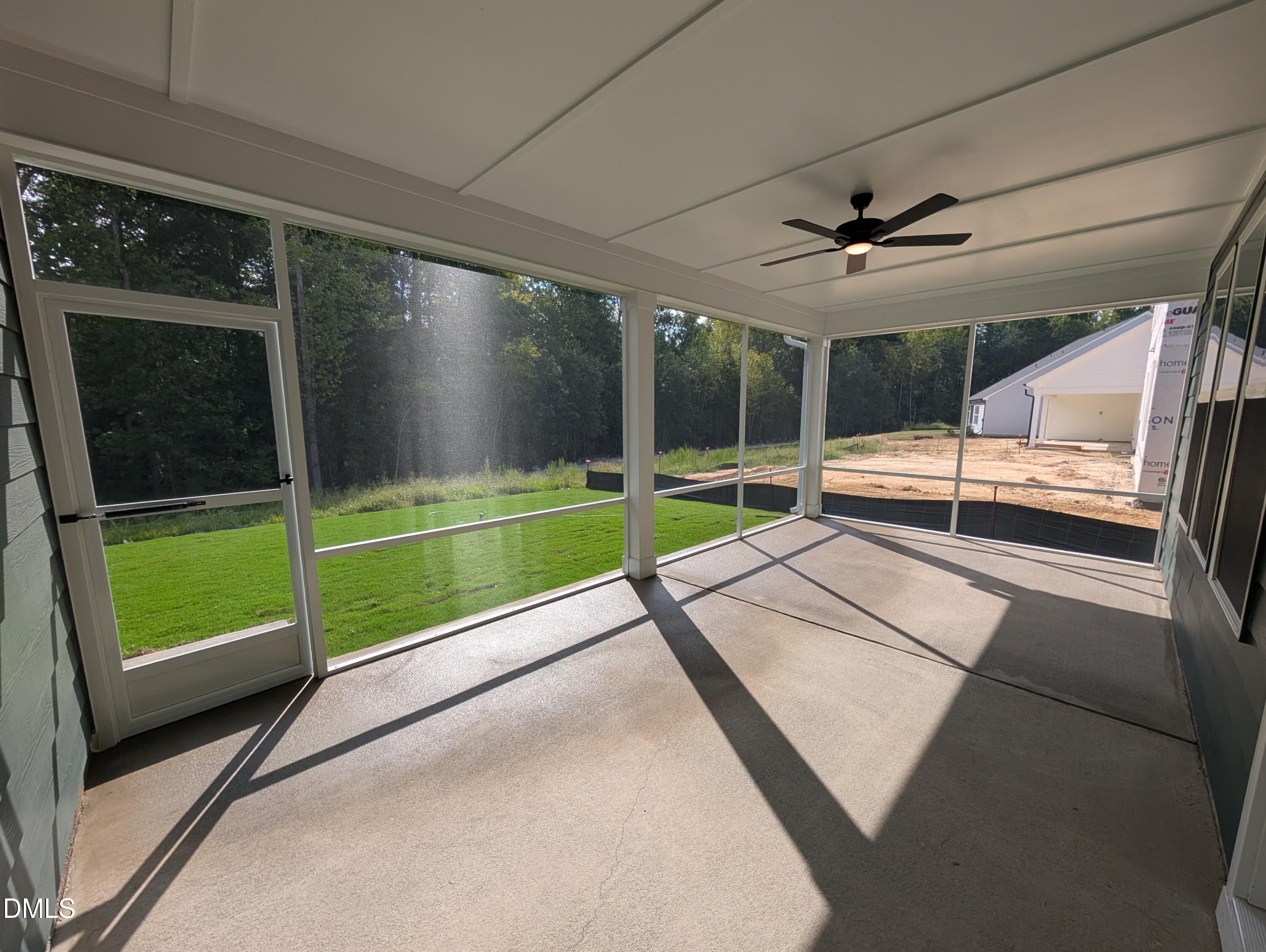 Screened-in back porch with ceiling fan overlooking fenced backyard in Davidson Homes The Magnolia A, Wendell Ridge, NC