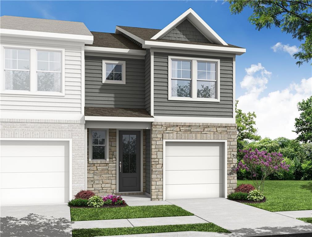 Modern 2-story Durant A home exterior with gray siding, stone accents, one-car garage, and landscaped yard in Stegall Village, Emerson, Georgia