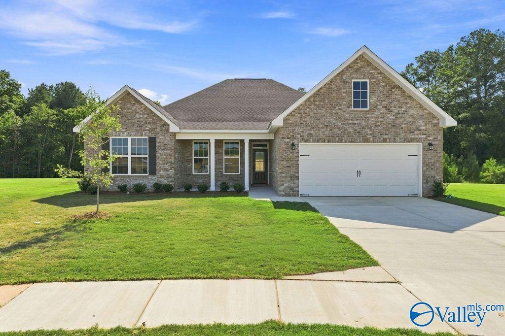 Brick exterior of The Rockford floor plan by Davidson Homes with 2-car garage and landscaped lawn in Cain Park, Hartselle, Alabama