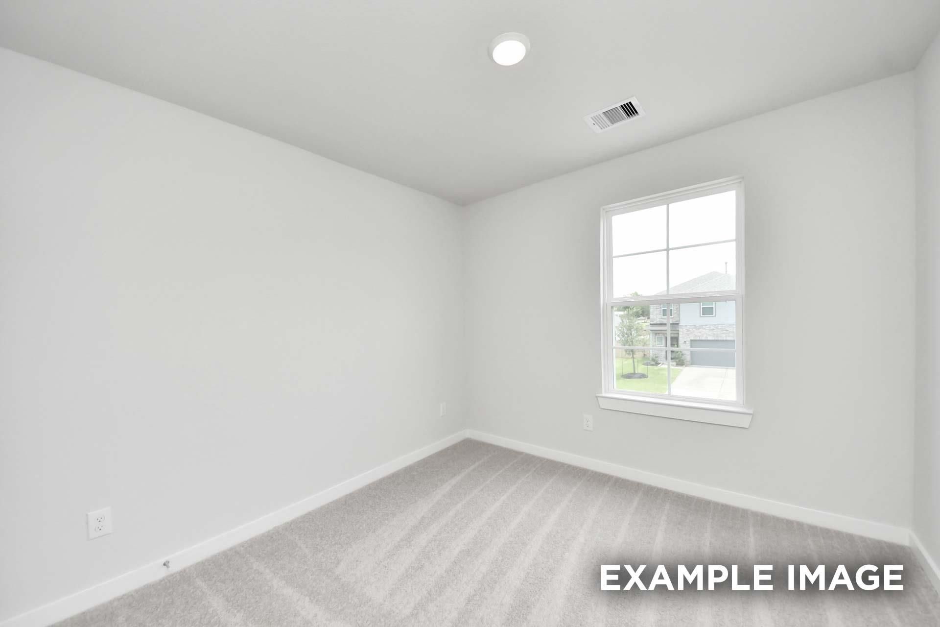 Bright bedroom with carpet flooring and white walls in Davidson Homes The Blanco E at Windmill Estates, Magnolia, Texas