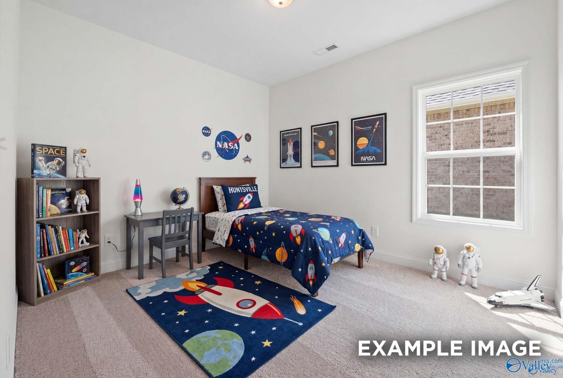 Space-themed bedroom with rocket decor in The Rockford B floor plan at Kendall Downs, Toney, Alabama.