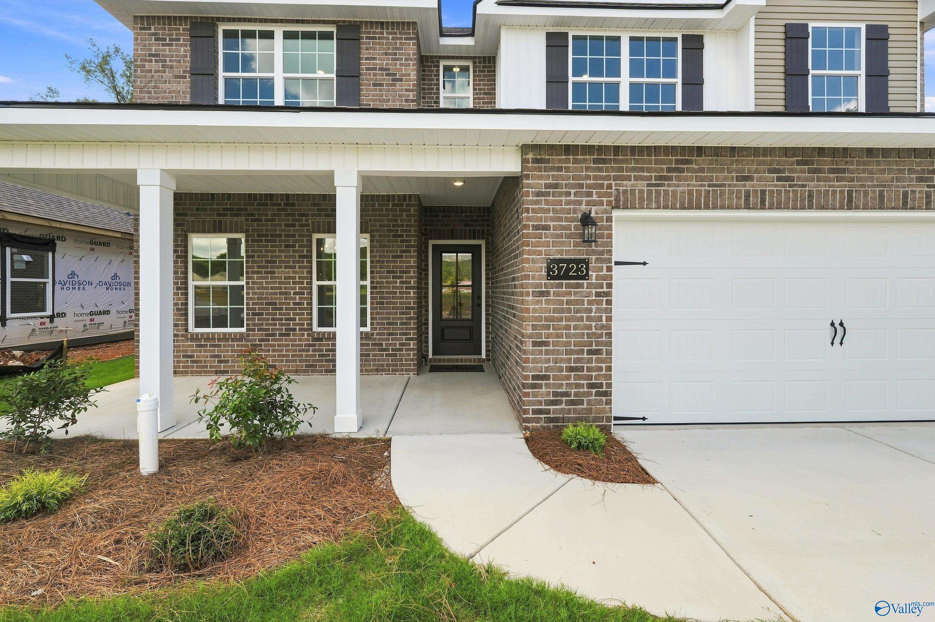 Brick facade of The Shelby B floor plan by Davidson Homes featuring a 2-car garage in Jaguar Hills, Huntsville, Alabama.