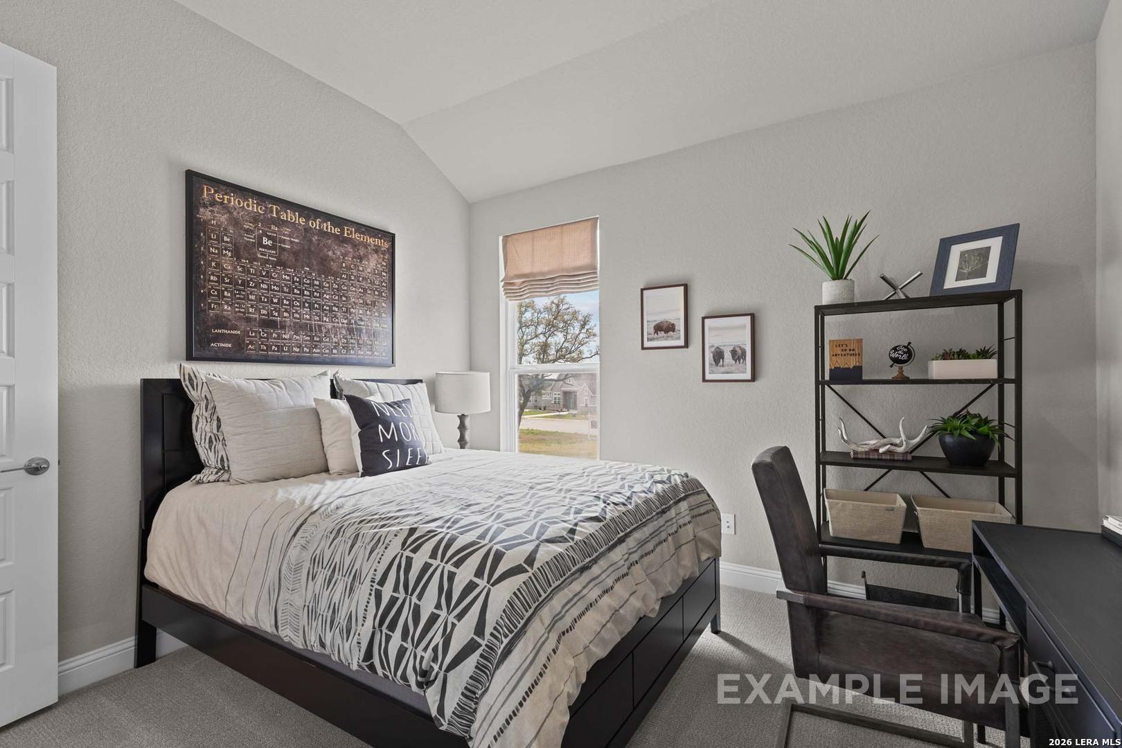 Modern bedroom with periodic table decor in The Garner C floor plan at The Reserve at Potranco Oaks, Castroville, Texas.