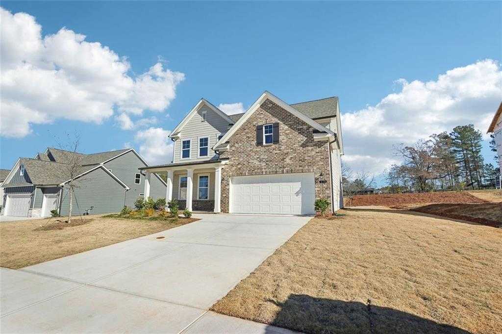 Modern two-story Hickory C home exterior with stone accents, 2-car garage, and driveway in Wehunt Meadows, Hoschton, Georgia