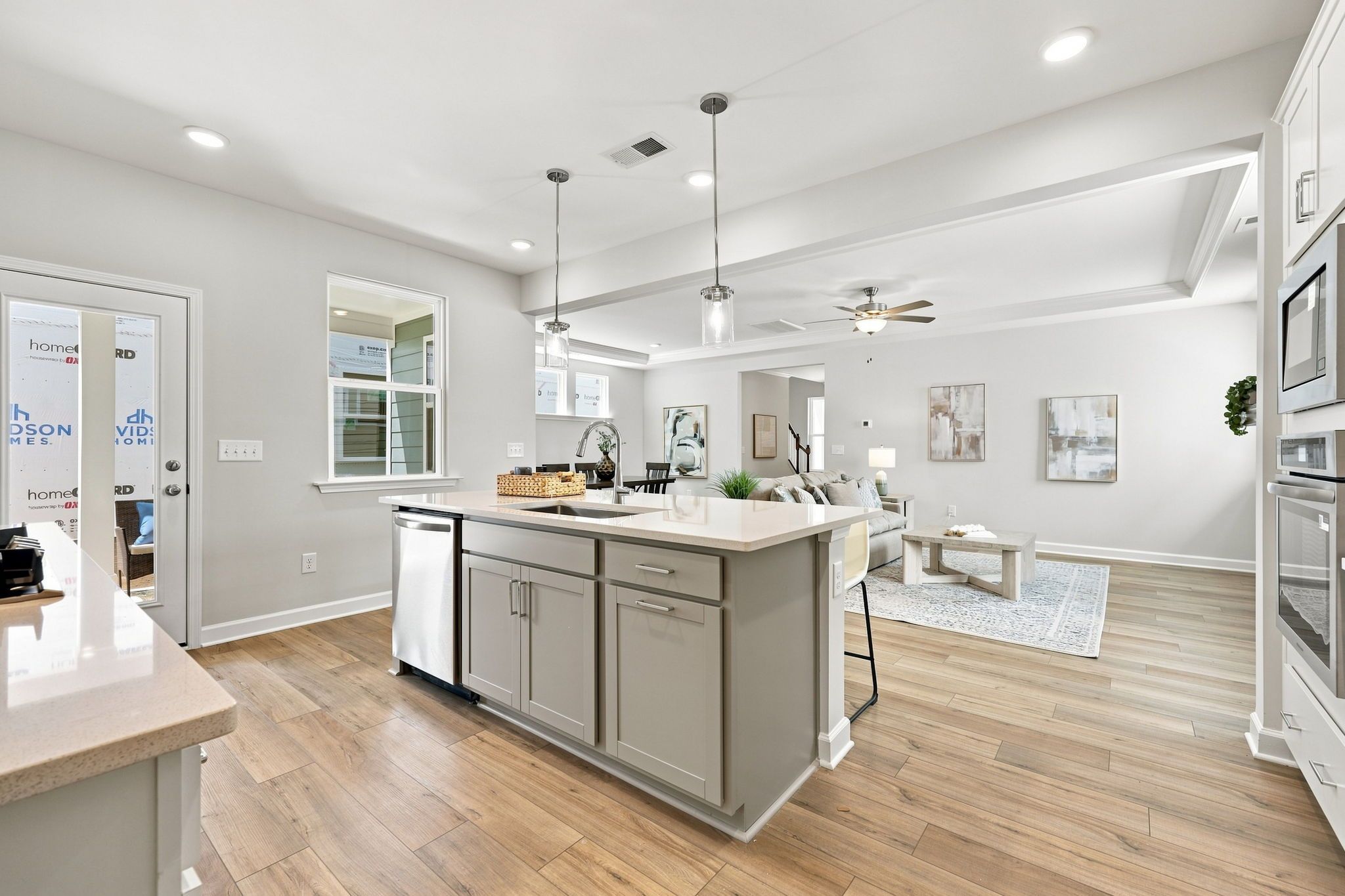 Open-concept kitchen and living area in The Jordan A by Davidson Homes with a central island and modern finishes.