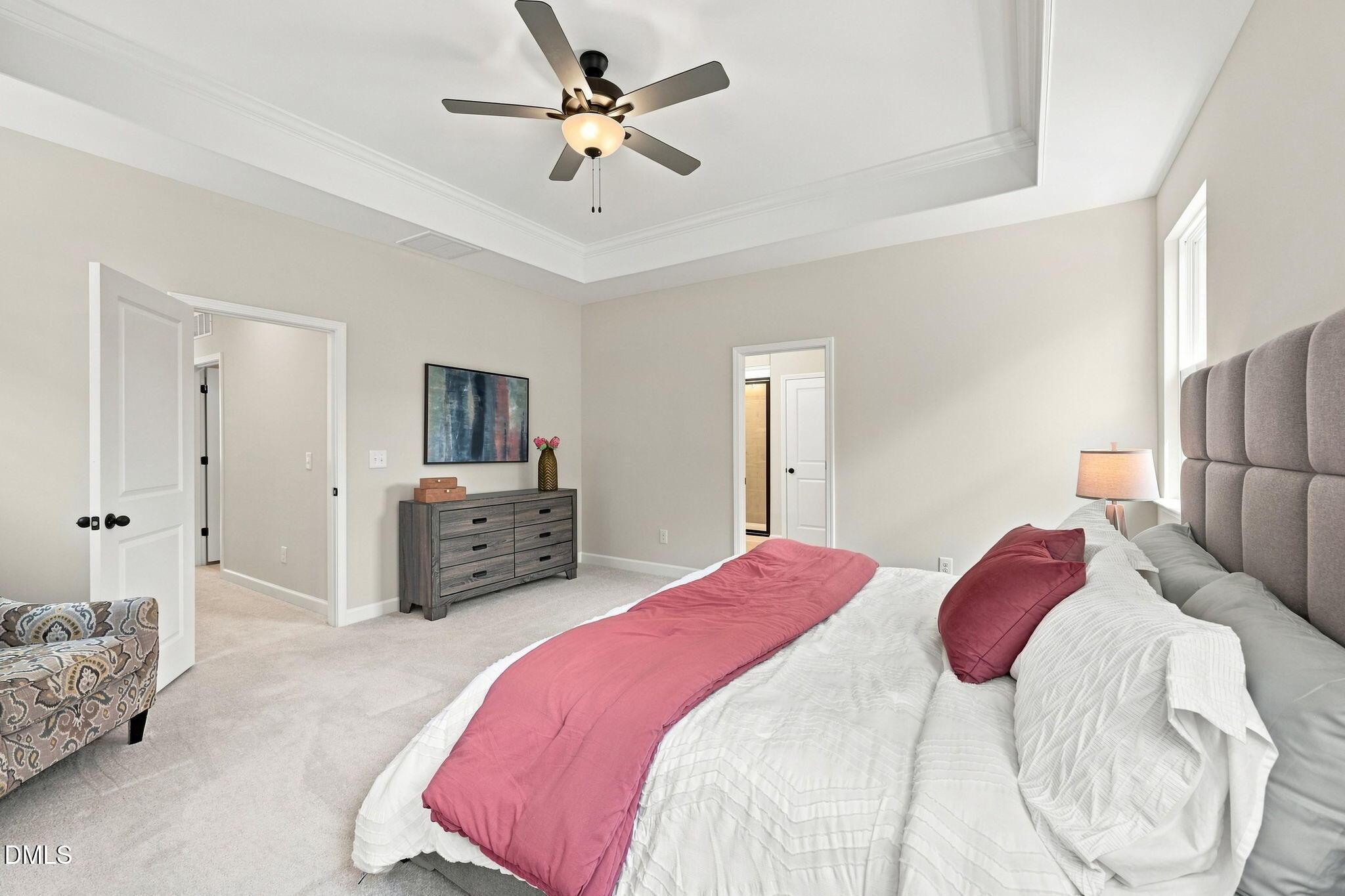 Spacious primary bedroom with tray ceiling in The Harris C floor plan at Forestville Yard, Knightdale, North Carolina.