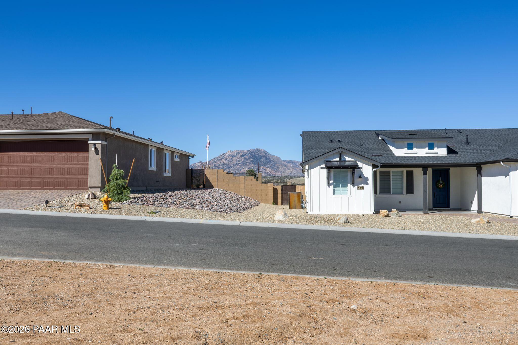 Modern white single-story home with 3-car garage by Davidson Homes in Westwood, Prescott, Arizona desert landscape