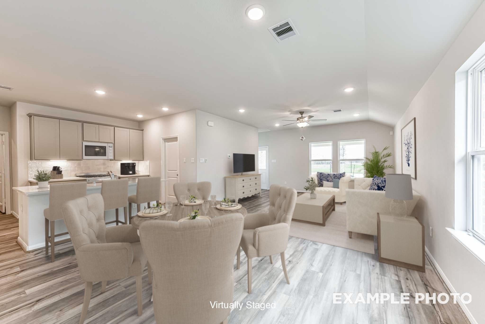 Open-concept living room and kitchen in The Laguna C by Davidson Homes, Sunterra, Katy, Texas with modern staging.