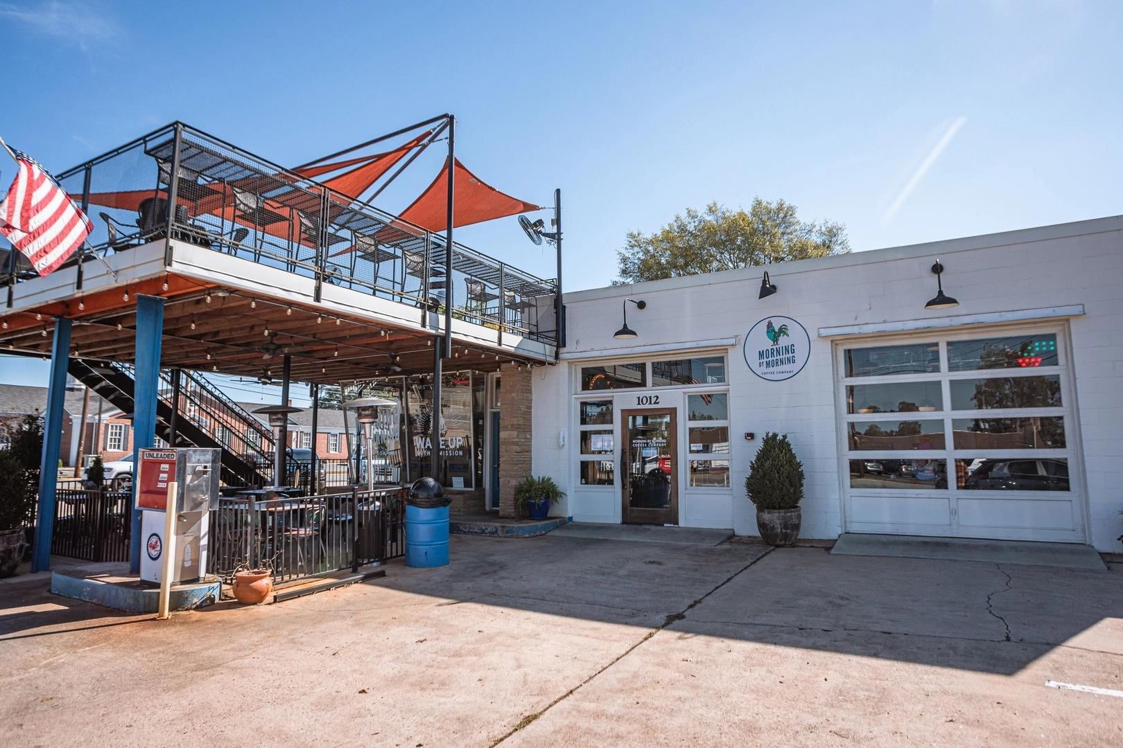 Elevated metal deck with orange canopy and American flag above Ivy Glen clubhouse in Perry, Georgia by Evermore Homes