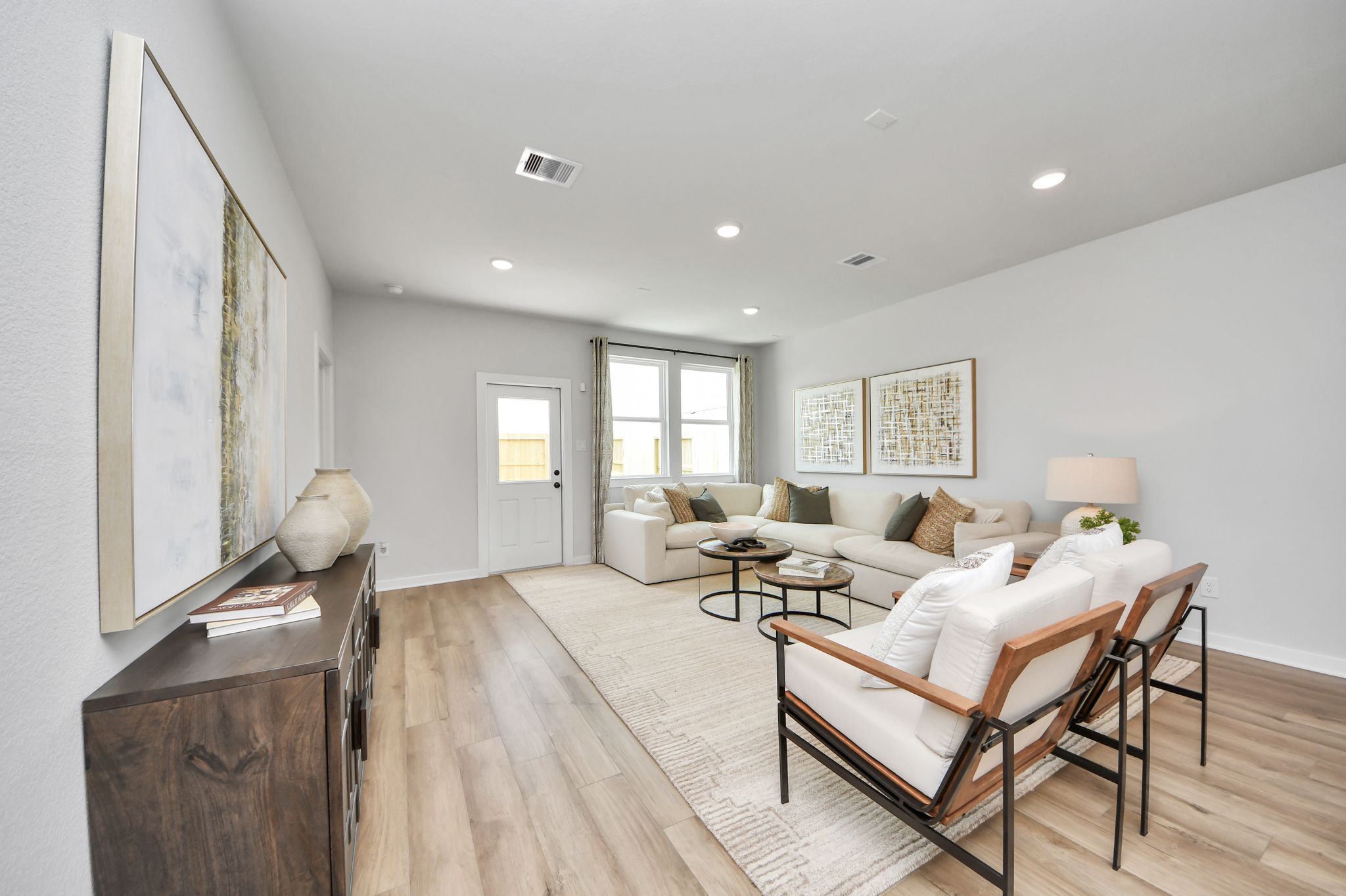 Bright, open-concept living room at Robins Landing in Houston, TX by Davidson Homes with modern decor and hardwood floors.