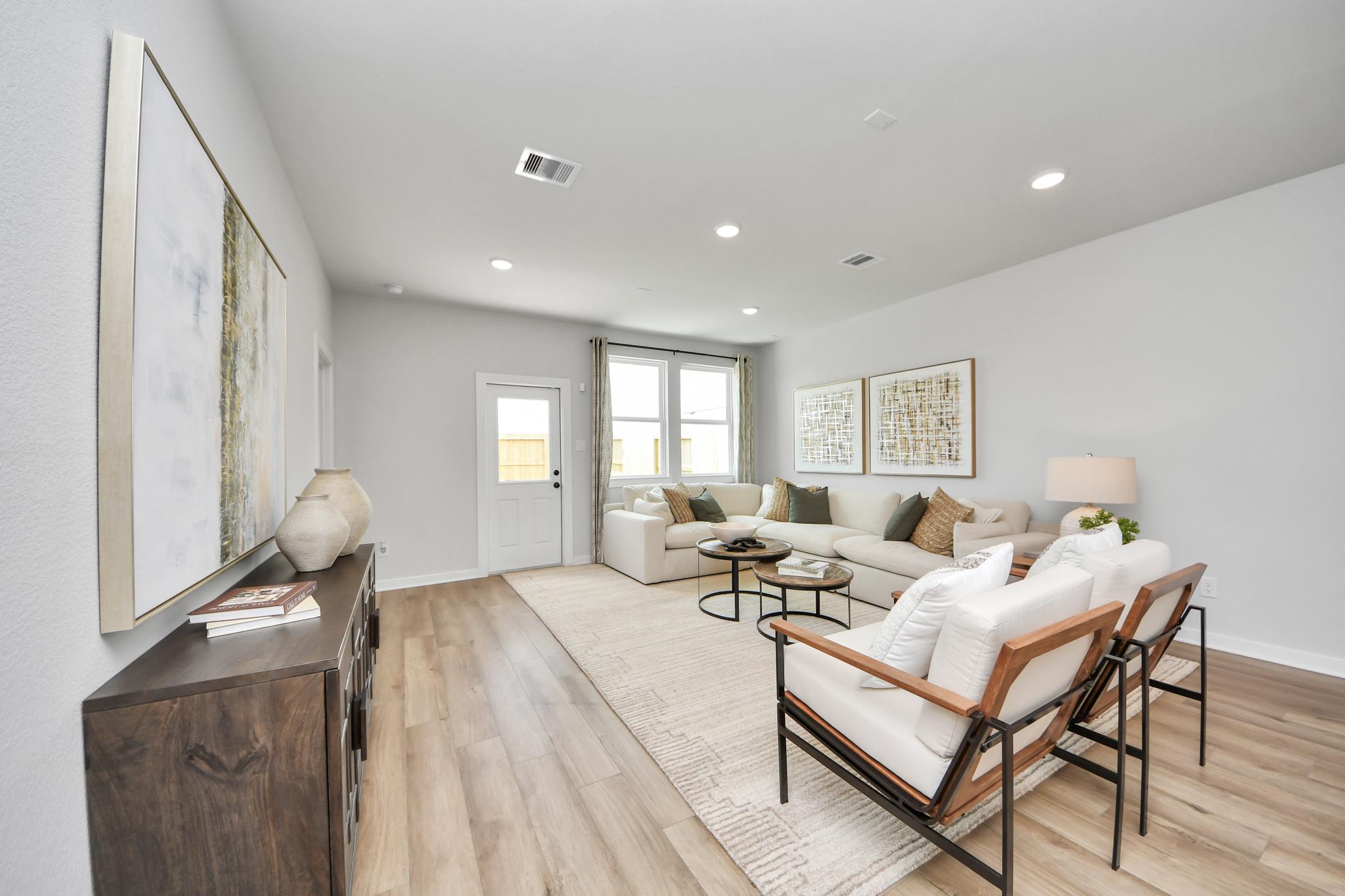 Bright, open-concept living room at Robins Landing in Houston, TX by Davidson Homes with modern decor and hardwood floors.