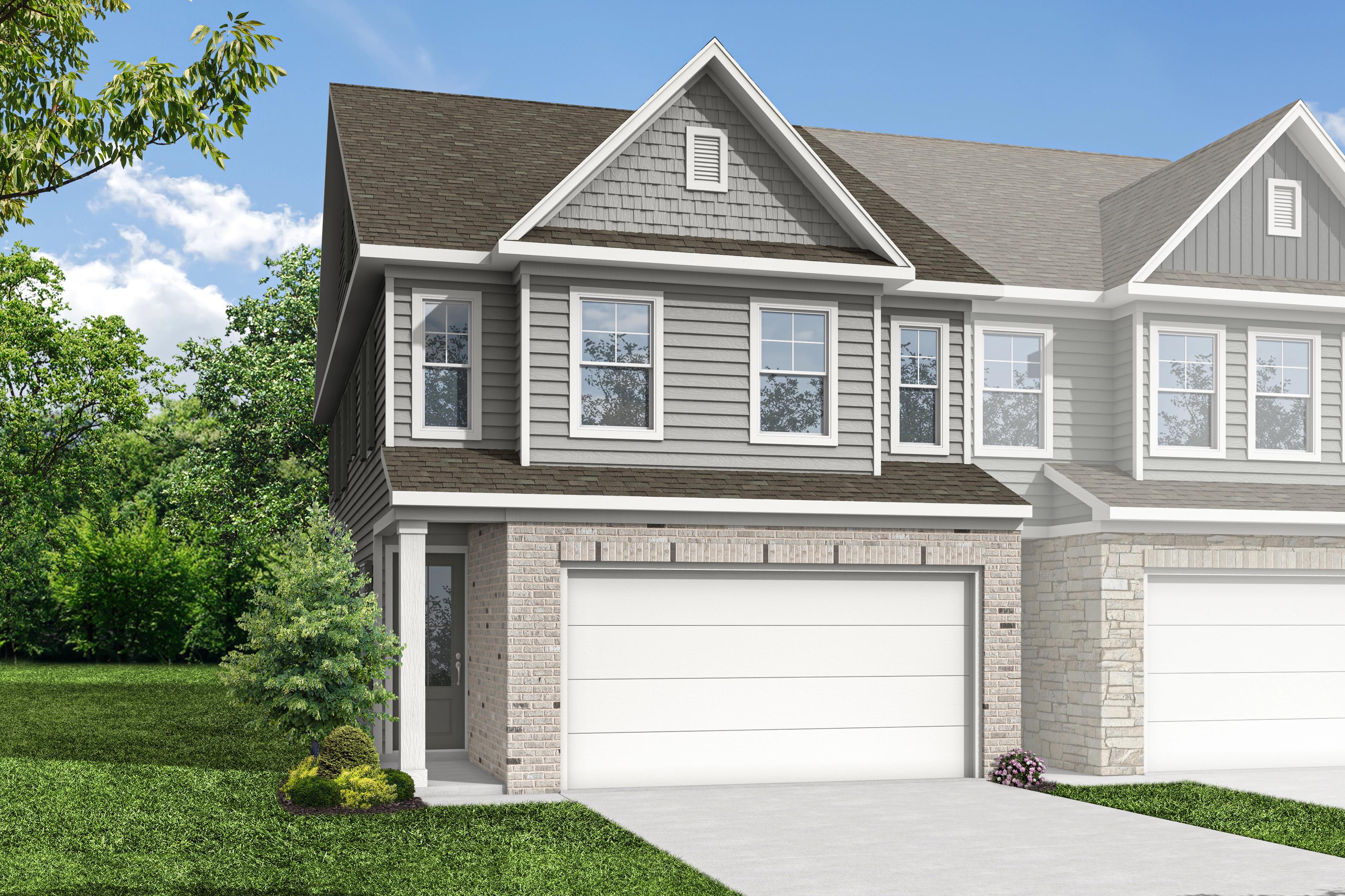 Modern 2-story multi-family duplex elevation of The Wake C with gray siding, brick details, dual 2-car garages, and lush green landscaping