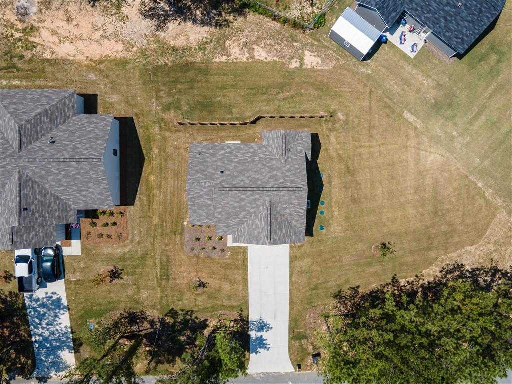 Aerial view of The Washington 3-bedroom single-story home by Evermore Homes, gray shingle roof, driveway, landscaped yard in Heatherbrook, Phenix City, Alabama