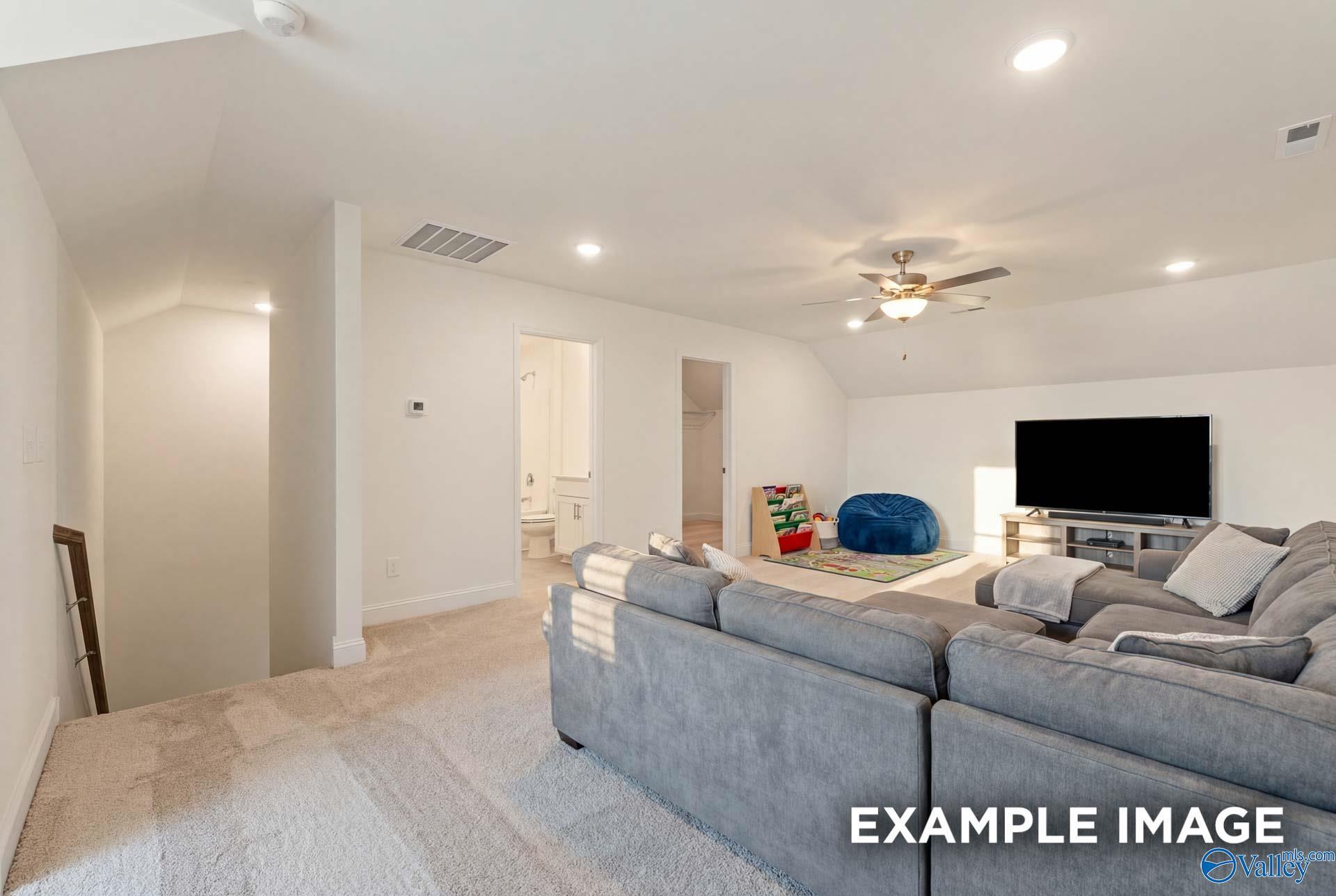 Spacious upstairs loft and media room in The Rockford B floor plan at Kendall Downs in Toney, Alabama.