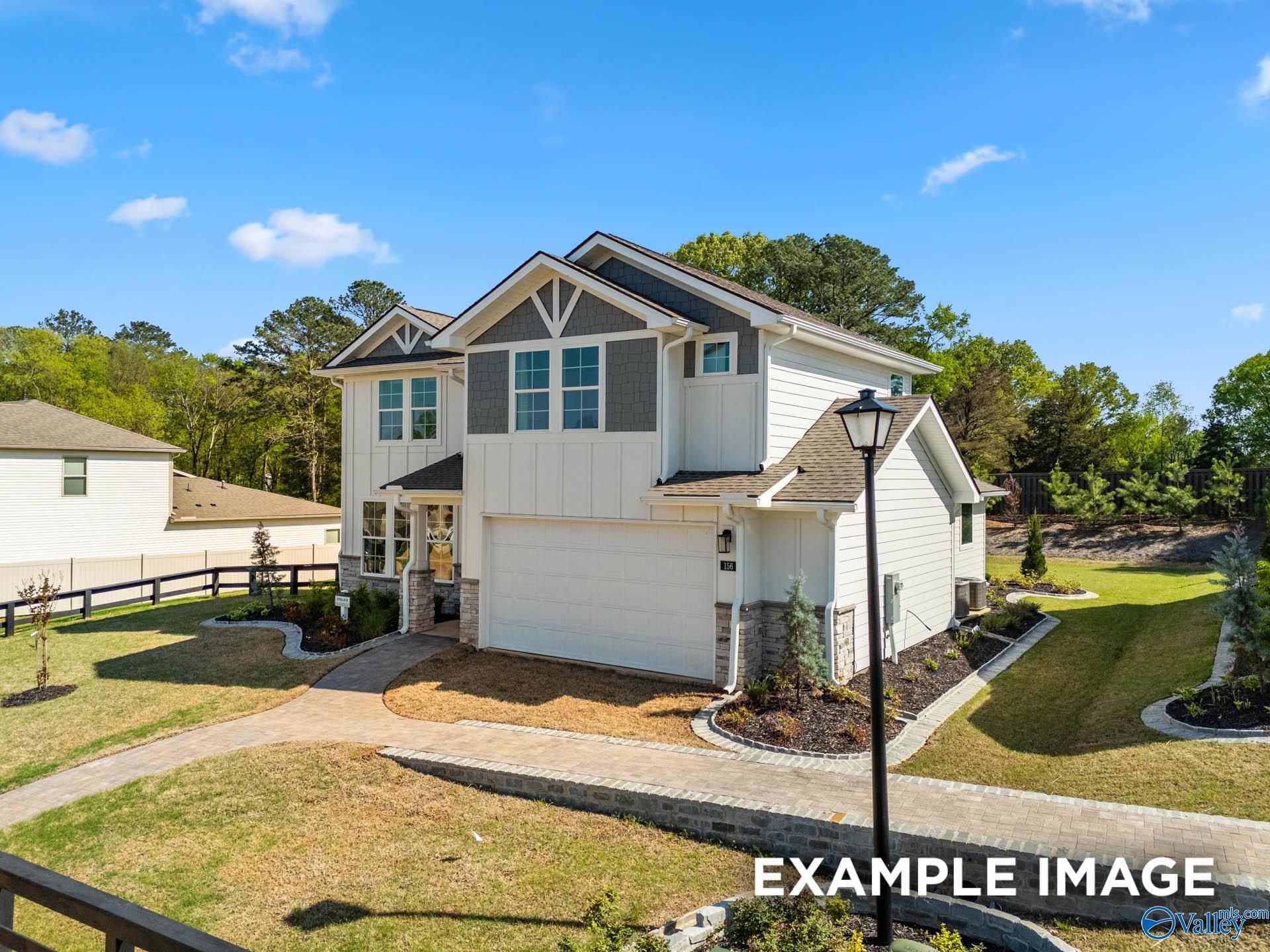 Modern two-story white home with 2-car garage, shake siding, and landscaped yard in Evergreen Mill, Madison, Alabama - Davidson Homes The Stella