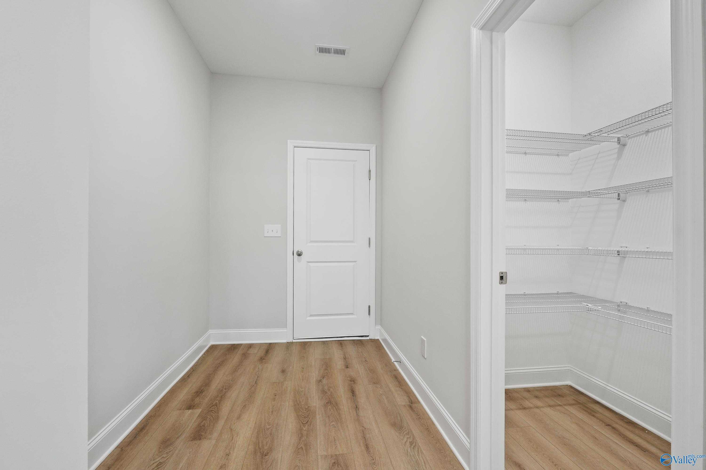 Spacious bedroom with walk-in closet and wire shelving in Davidson Homes The Camden, Pavilion, Huntsville, Alabama