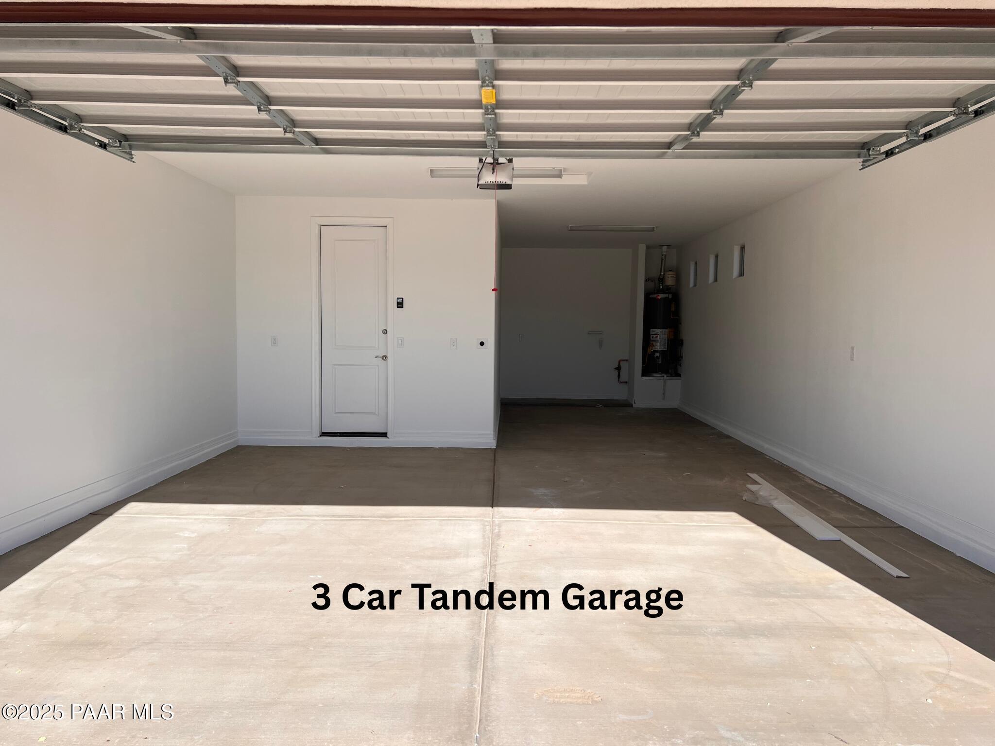 Spacious 3-car tandem garage with concrete flooring and utility storage in Davidson Homes The Inspiration C, Prescott Valley, Arizona