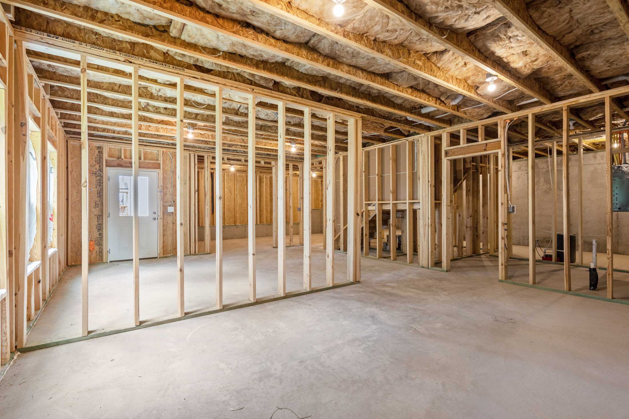 Wood framing and insulation in The Ash B garage, 3-bedroom Davidson Homes design in Hoschton, GA