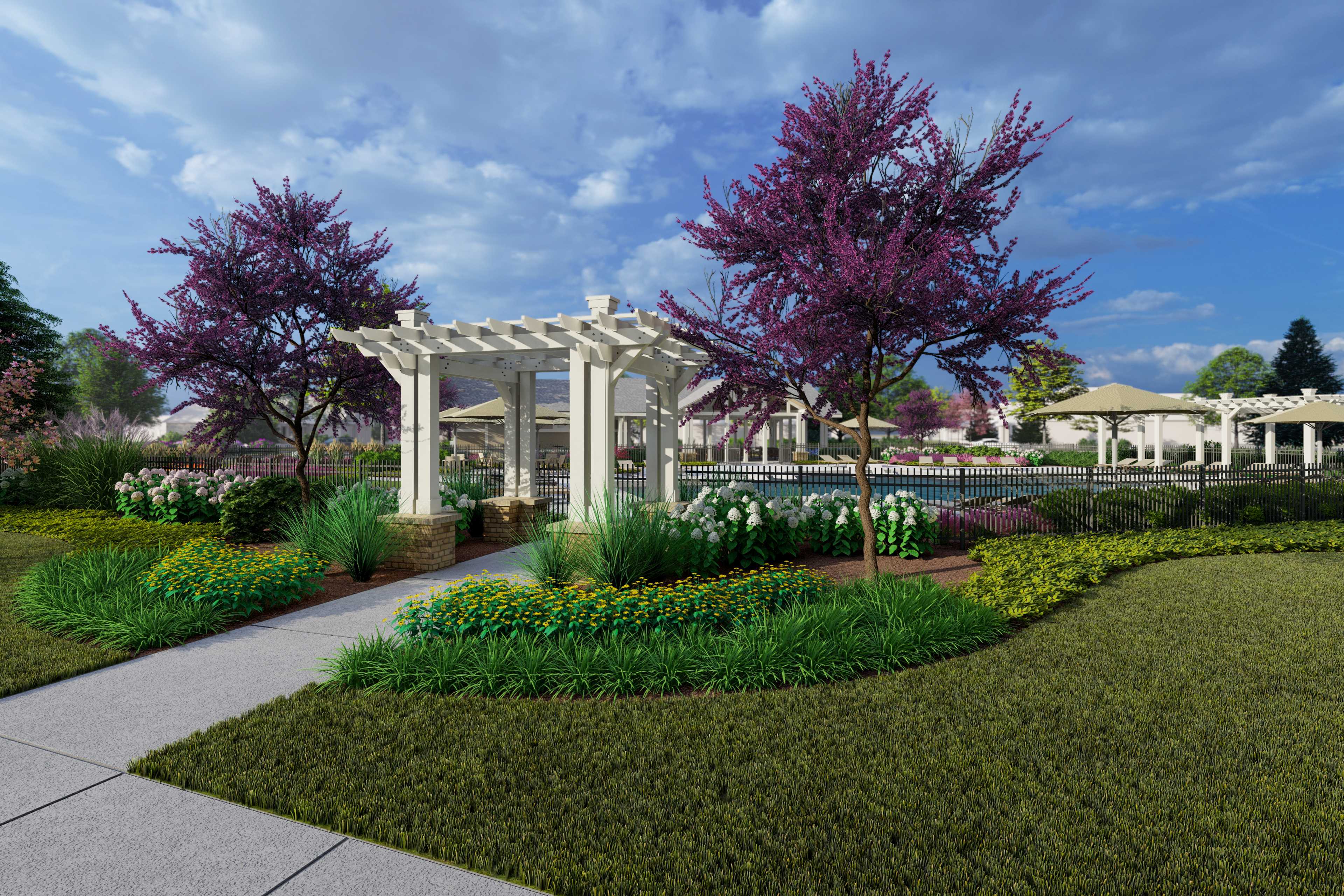 White pergola entrance to pool area at Creekside in Harvest Alabama with purple blooming trees and vibrant landscaped gardens