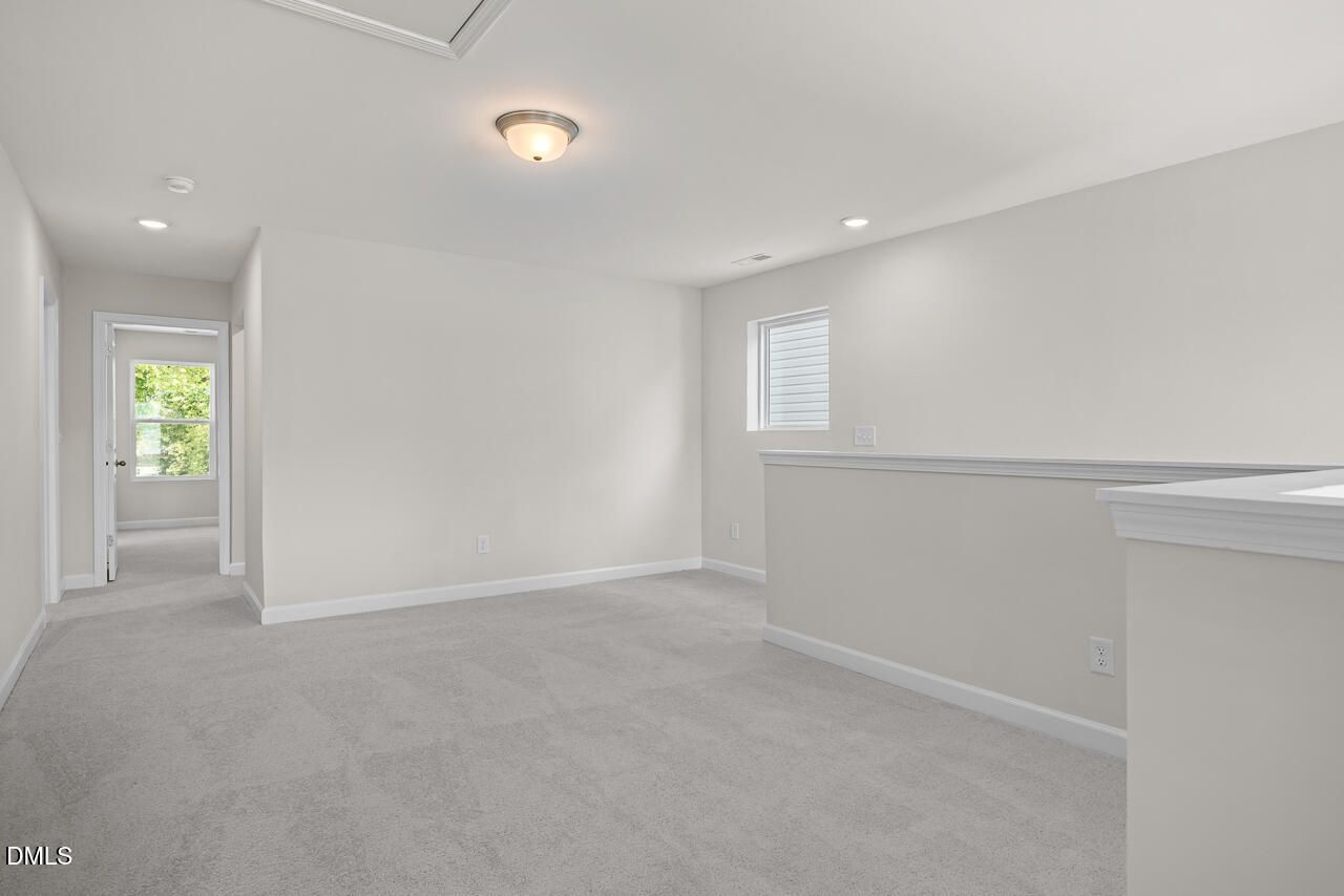 Spacious carpeted loft area in The Gavin A floor plan by Davidson Homes at Gregory Village in Lillington, NC.
