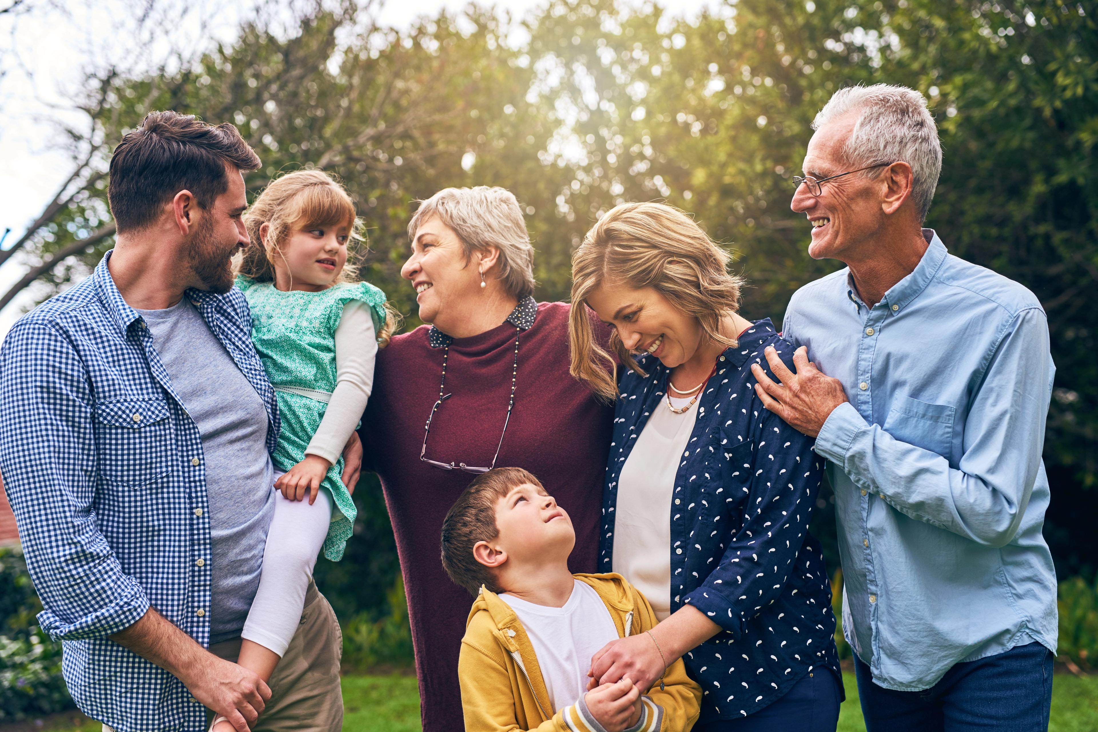 Joyful multi-generational family smiling outdoors at The Villas at Barnett's Crossing in Madison, Alabama