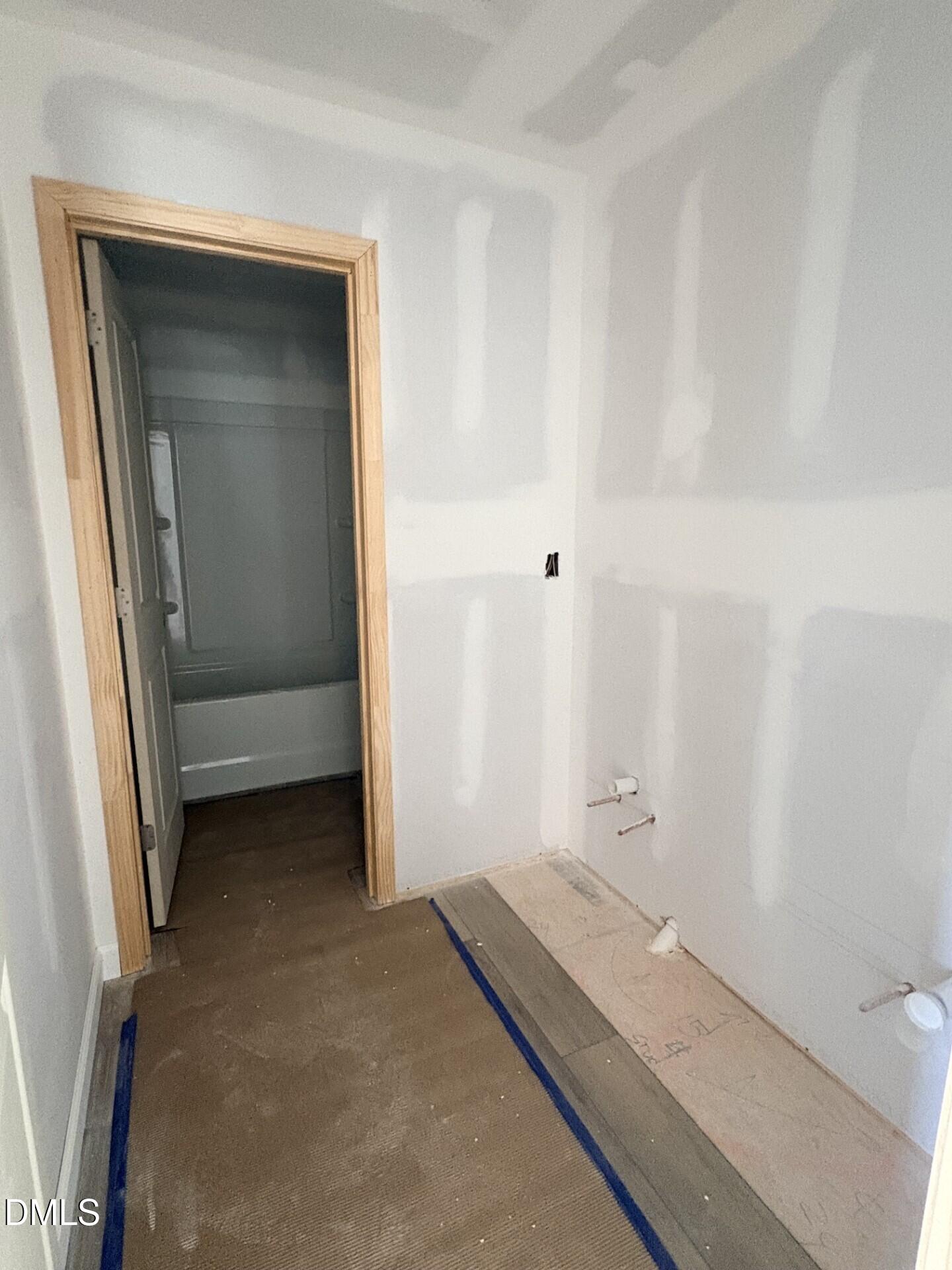 Unfinished bathroom with drywall and plumbing prepped for vanity in The Ash C floor plan at Woodland Crossing, Zebulon, NC.