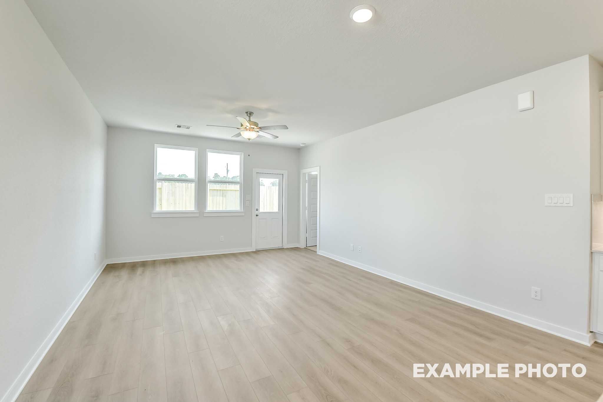 Spacious open-concept living area in The Colorado by Davidson Homes with luxury vinyl plank flooring and bright white interiors