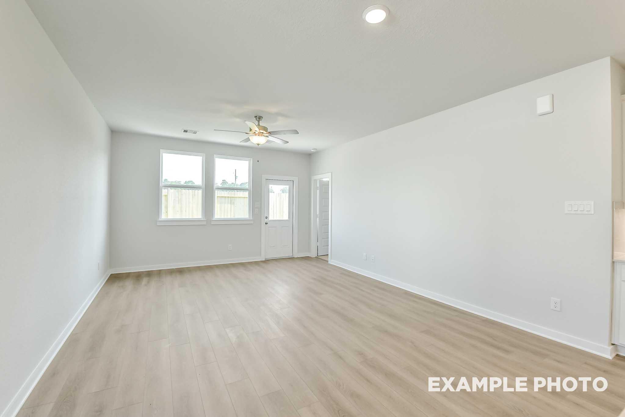 Spacious open-concept living area in The Colorado by Davidson Homes with luxury vinyl plank flooring and bright white interiors