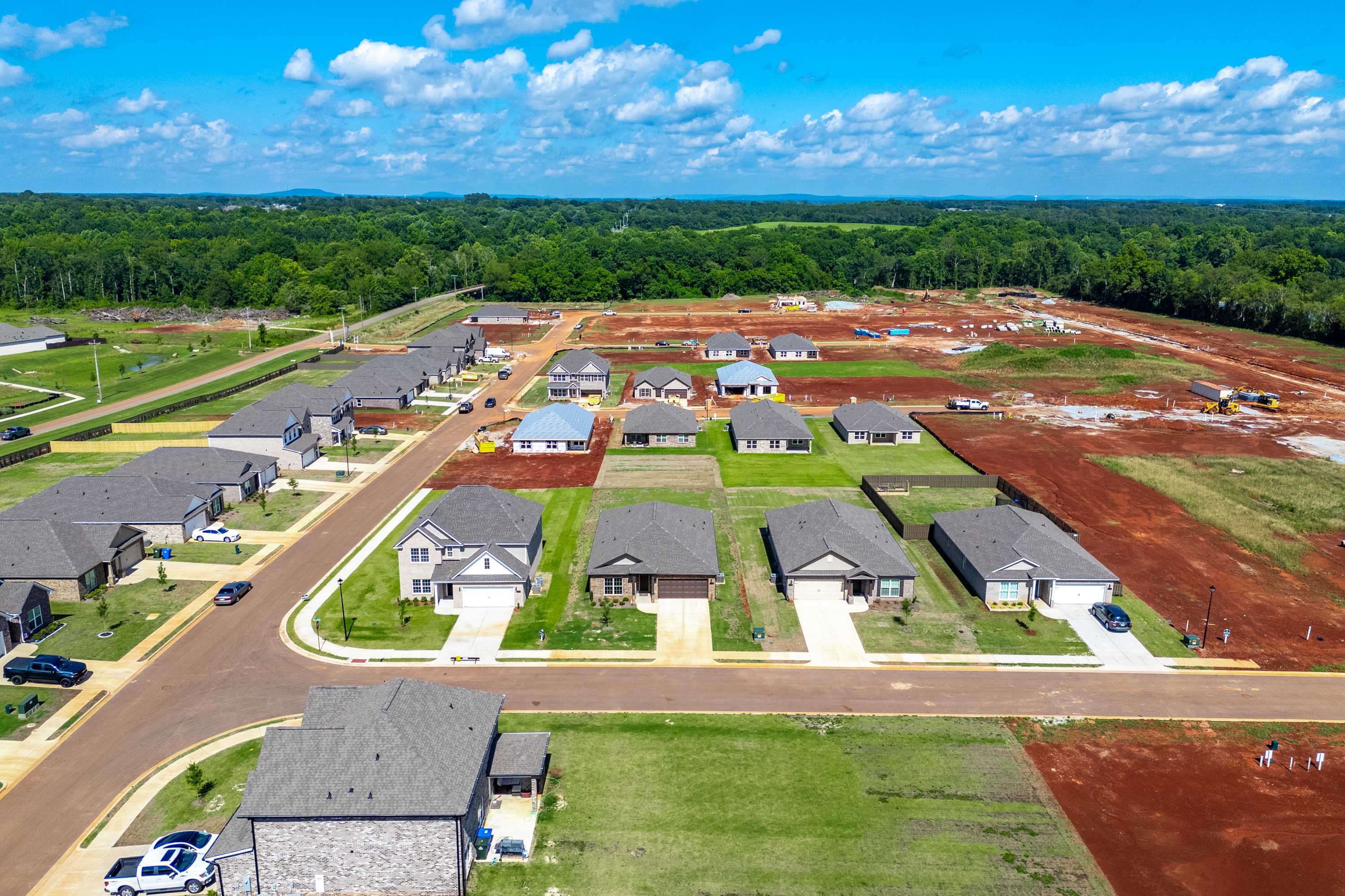 Aerial view of new homes under construction at The Meadows in Athens Alabama by Davidson Homes with wooded surroundings
