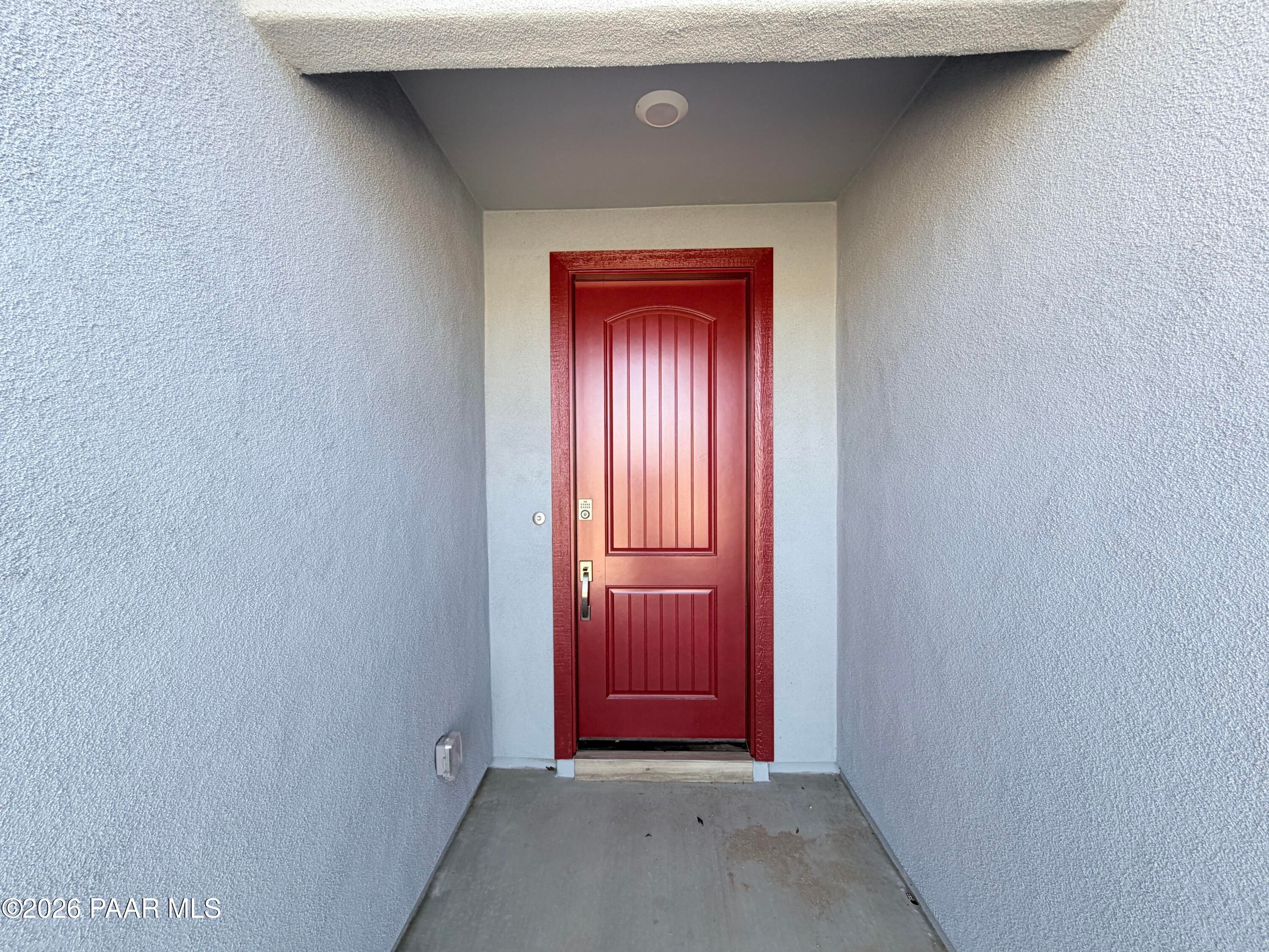 Bright red front door of The Inspiration C floor plan at North Ridge at Pronghorn Ranch in Prescott Valley, Arizona.
